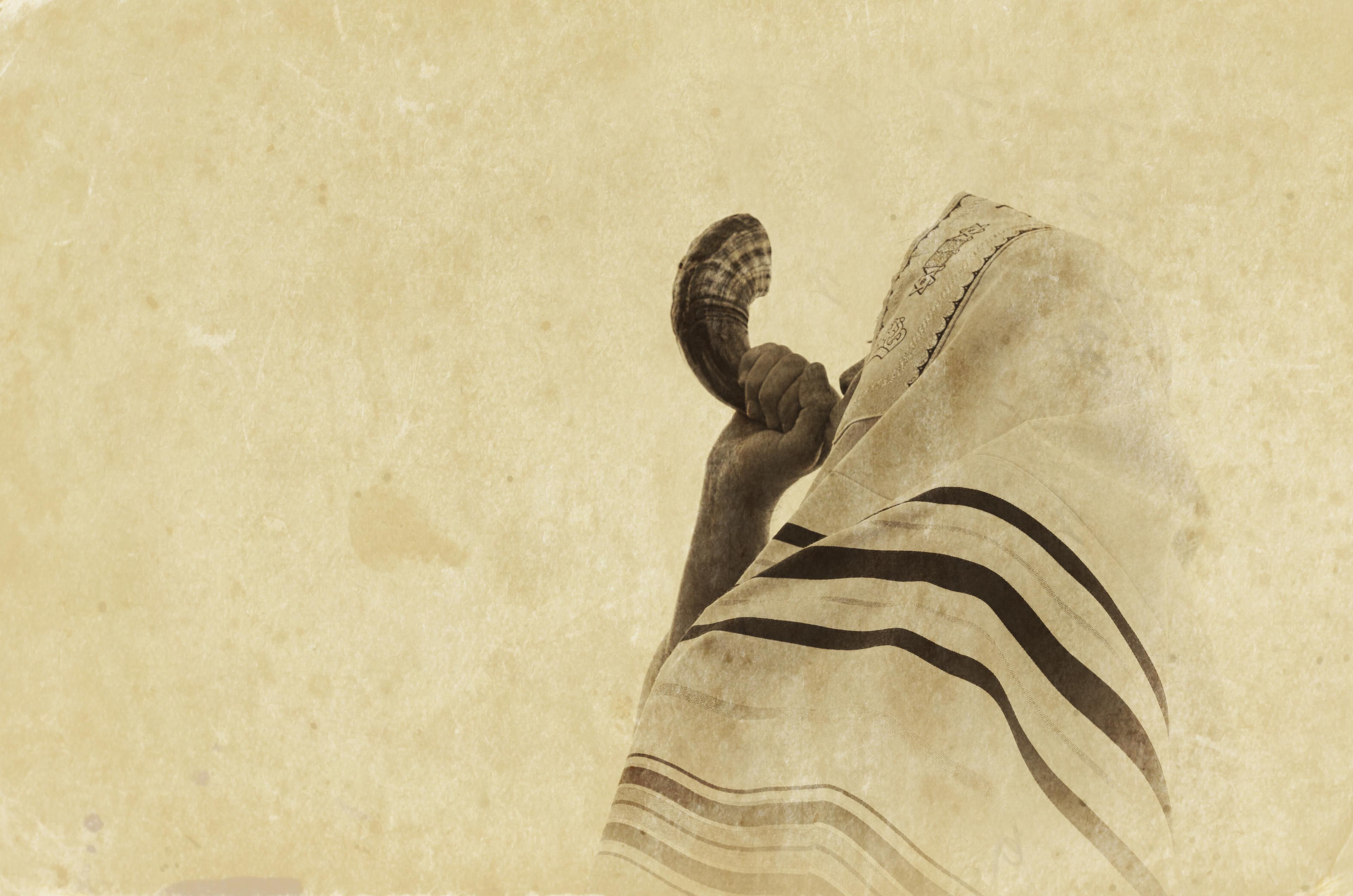 Jewish man blowing the Shofar (horn) 