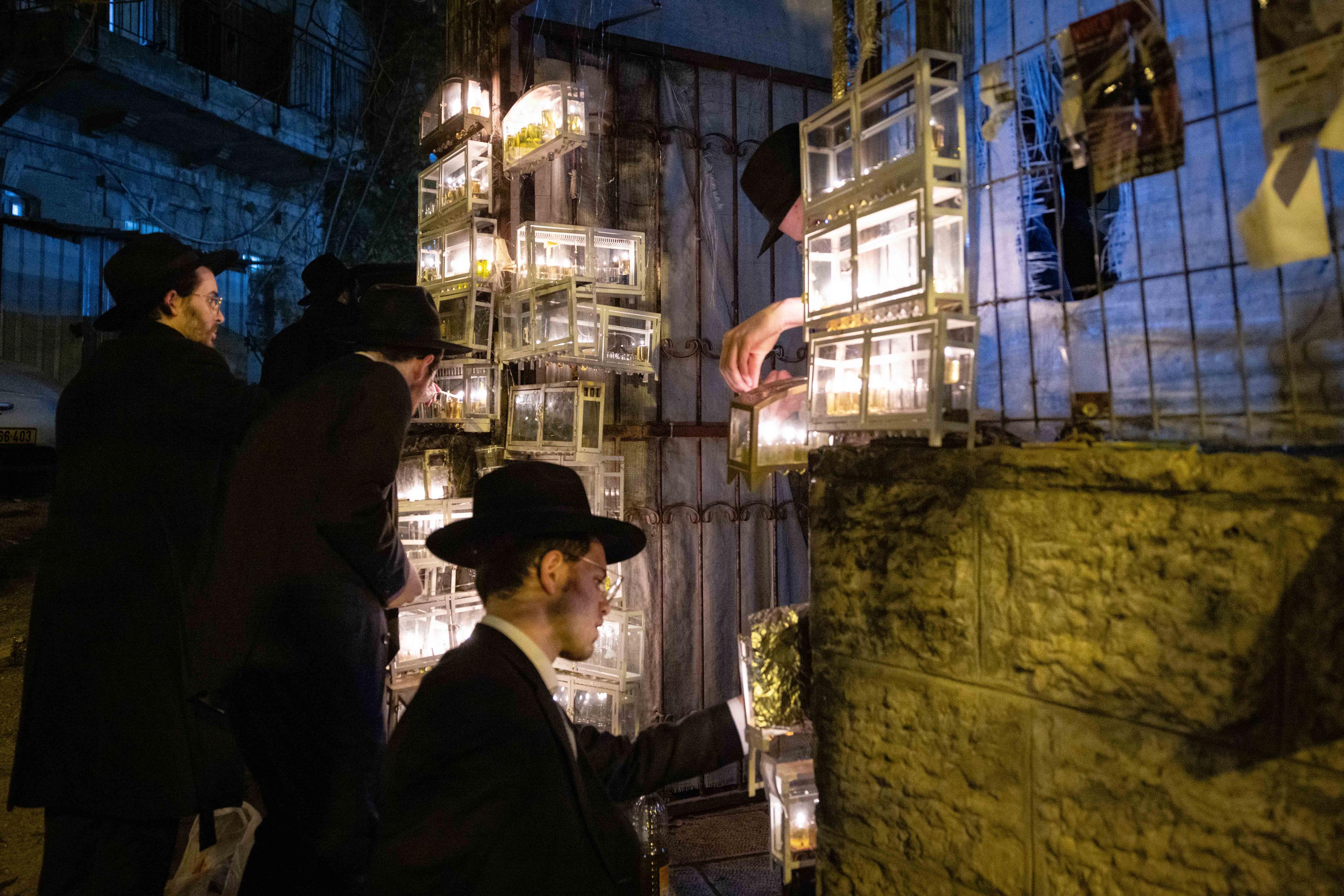 Ultra-Orthodox Jews light candles during the Jewish holiday of Hanukkah, in Jerusalem's Mea Shearim neighbourhood on December 28, 2024 Ultra-Orthodox Jews light candles during the Jewish holiday of Hanukkah, in Jerusalem's Mea Shearim neighbourhood on December 28, 2024