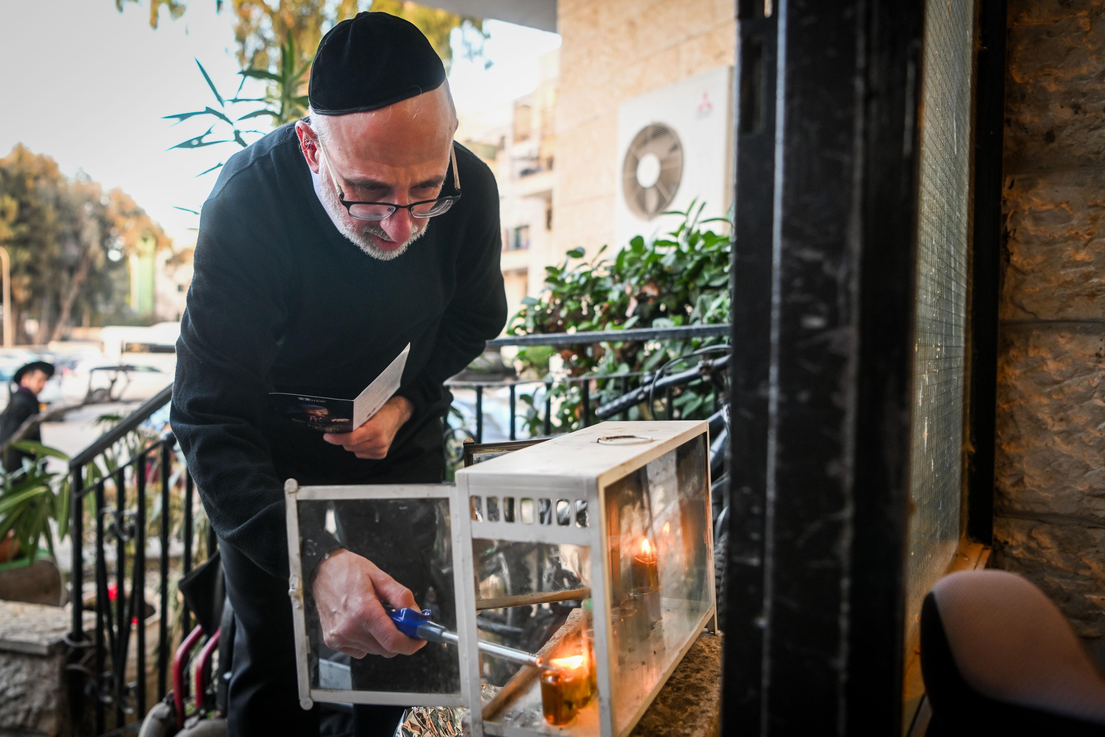 A Jewish family light candles on during the Jewish holiday of Hanukkah, in Jerusalem on December 27, 2024 A Jewish family light candles on during the Jewish holiday of Hanukkah, in Jerusalem on December 27, 2024