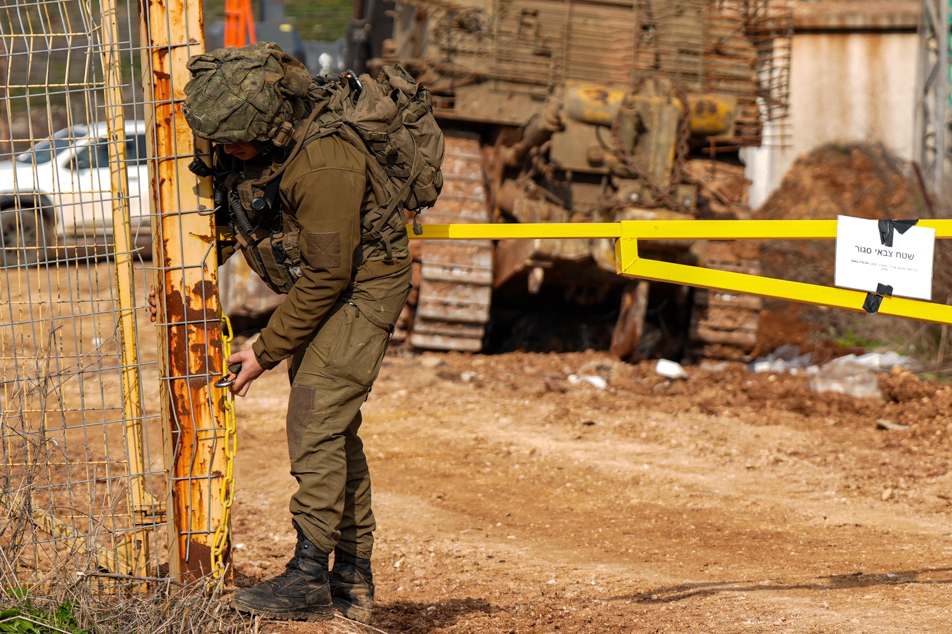 IDF soldier closing border gate with Lebanon. IDF soldier closing border gate with Lebanon.