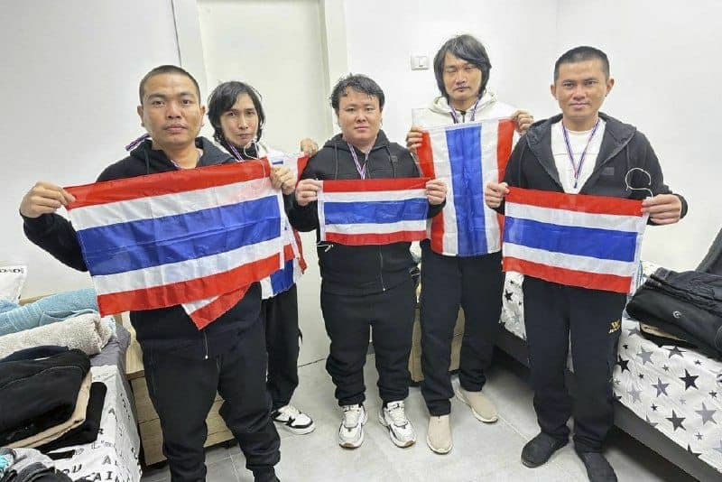 Thai hostages who were freed from Hamas captivity, from left to right, Surasak Lumnau, Sathian Suwannakham, Bannawat Saethao, Watchara Sriaoun and Pongsak Thaenna, hold the Thailand flag