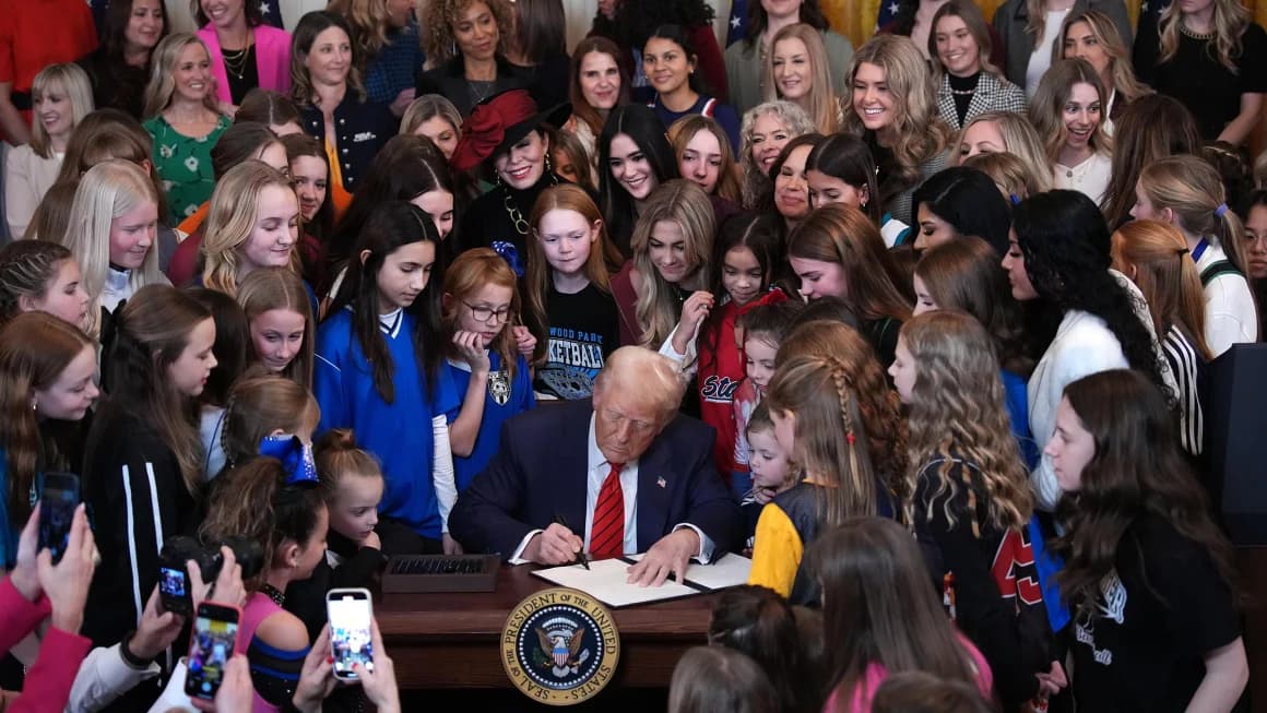 President Donald Trump joined by women athletes signs the “No Men in Women’s Sports” executive order in the East Room at the White House on Wednesday in Washington, DC