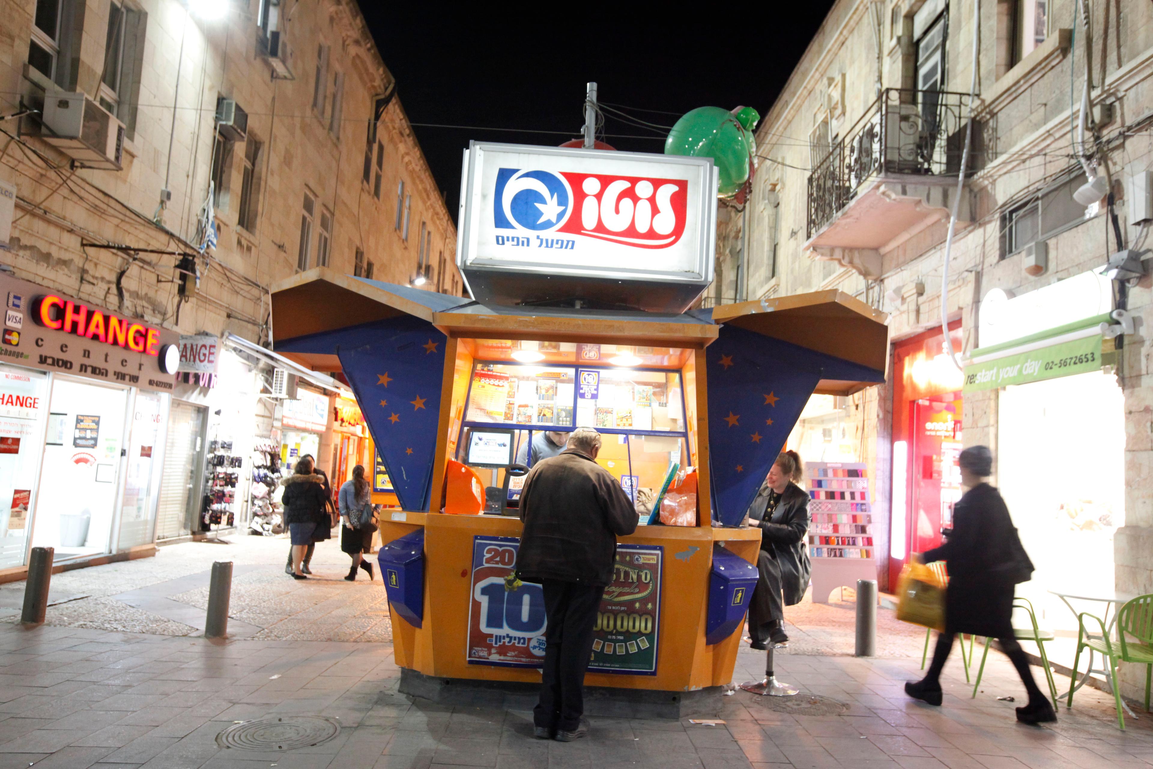An Israeli man plays the lotto at a lotto booth in the center of Jerusalem