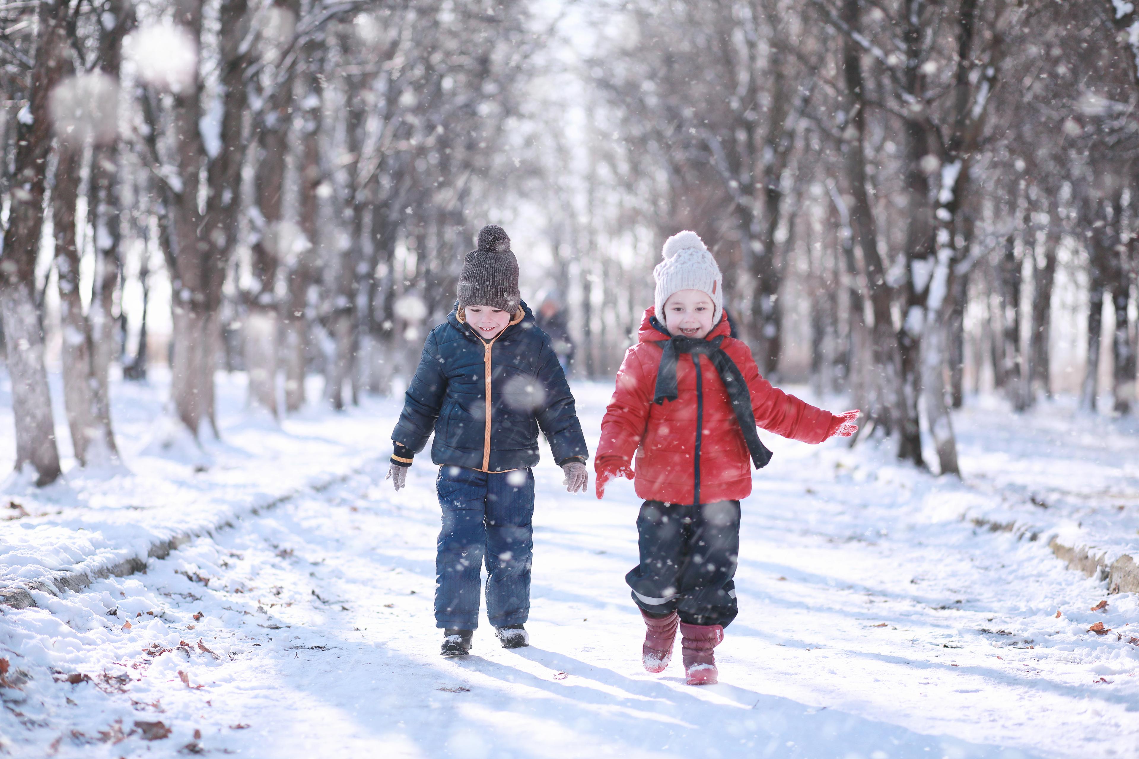 Kids walk in the park with first snow 