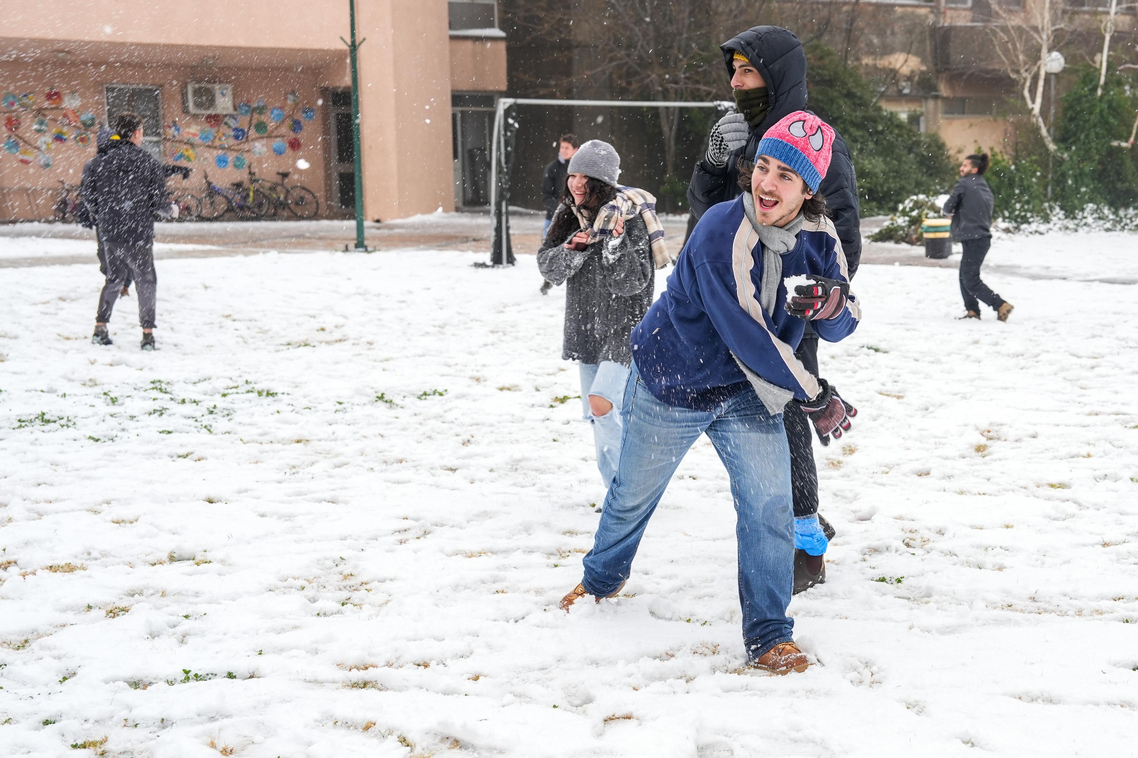 People enjoy the snow in Kibbutz El Rom, in the Golan Heights, Northern Israel, February 06, 2025