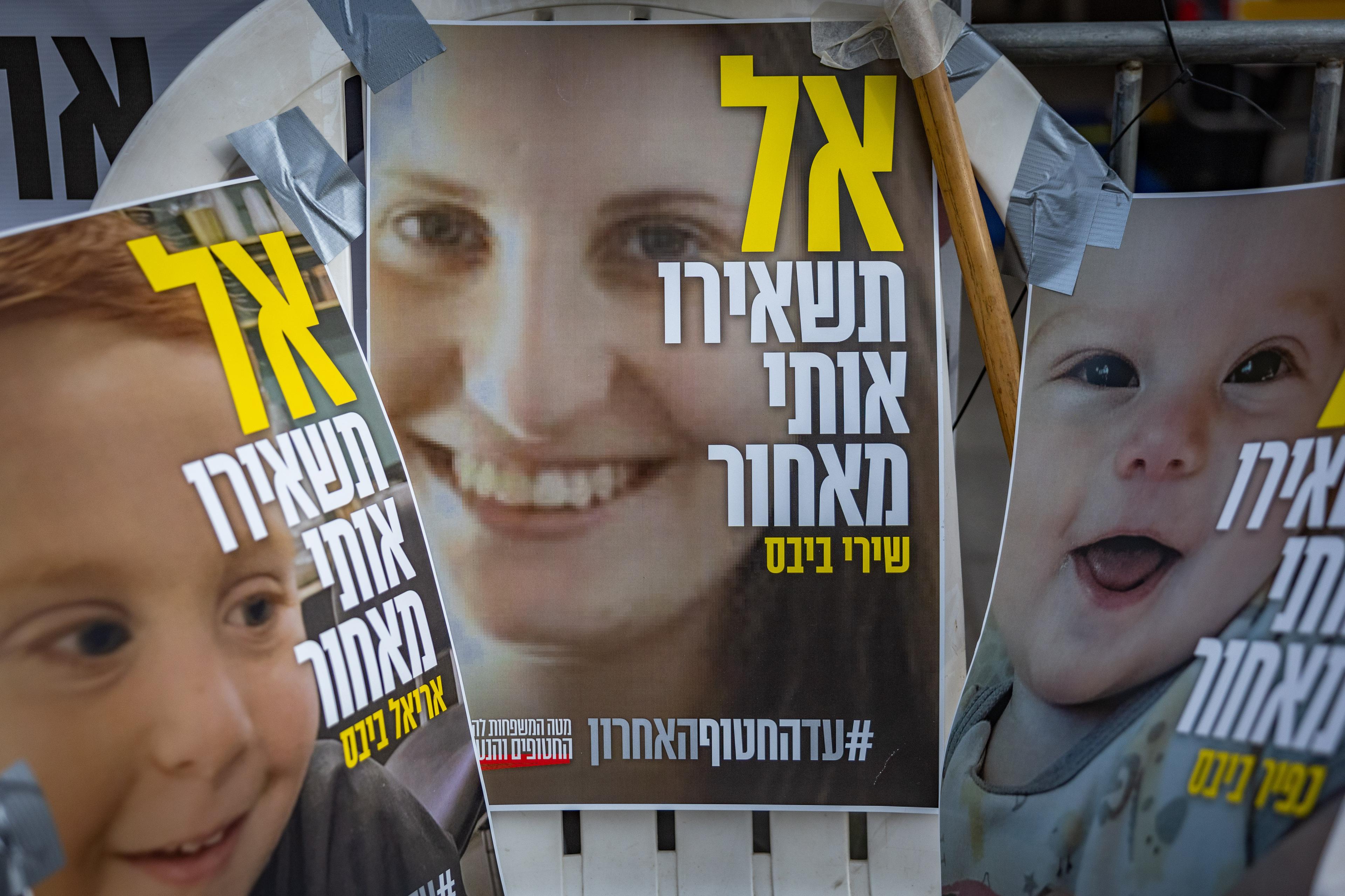 Pictures of Shiri Bibas and her children Kfir and Ariel hang outside the protest tent calling for the release of Israeli hostages in the Gaza Strip, outside the Prime Minister's residence in Jerusalem, February 19, 2025.