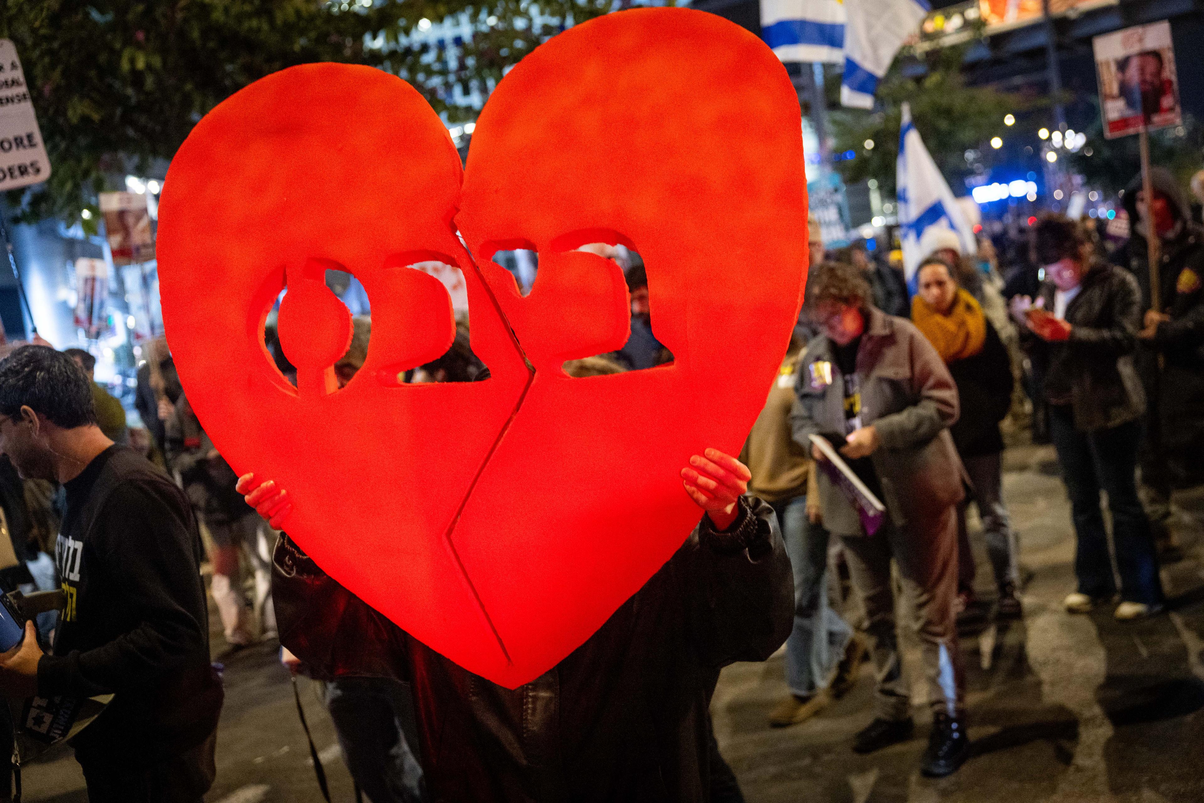 People gather outside Hakirya base in Tel Aviv, on the day of the release of the bodies of four Israeli hostages from Hamas captivity, February 20, 2025