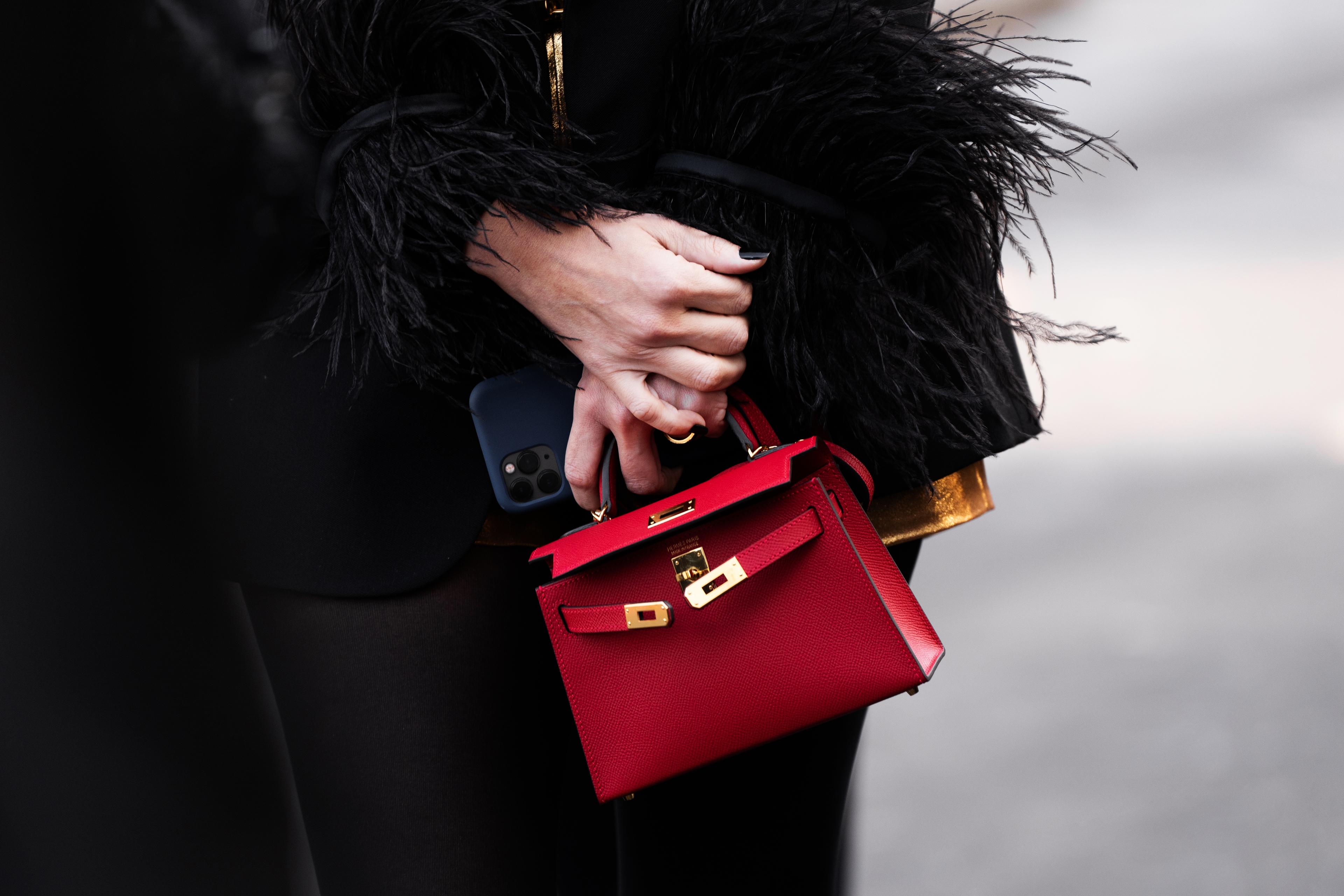 Woman wears Hermes Kelly bag