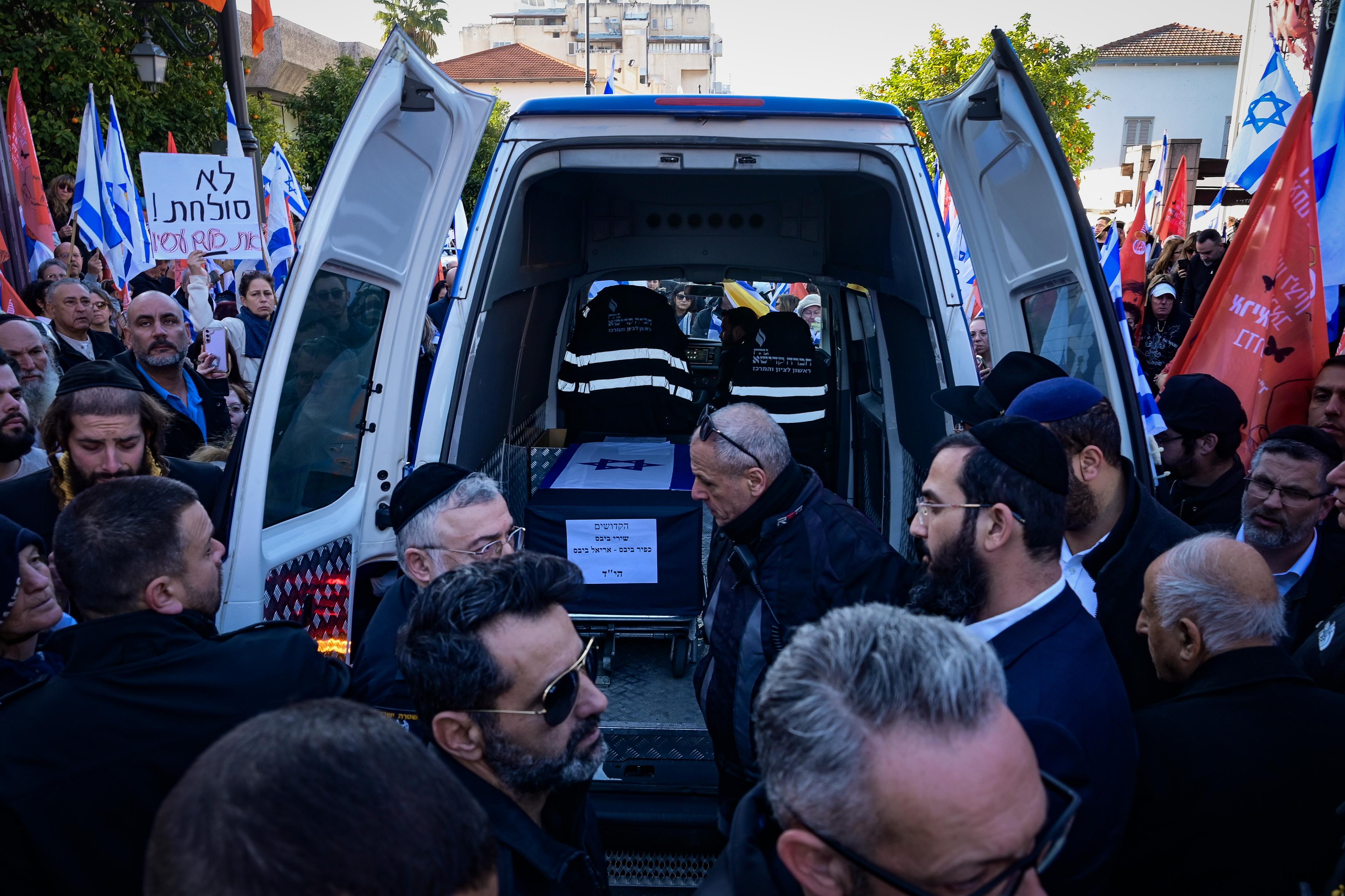 People pay their respects during the funeral service of late Israeli hostages Shiri Bibas and her children Ariel and Kfir in Rishon LeZion, February 26, 2025. 