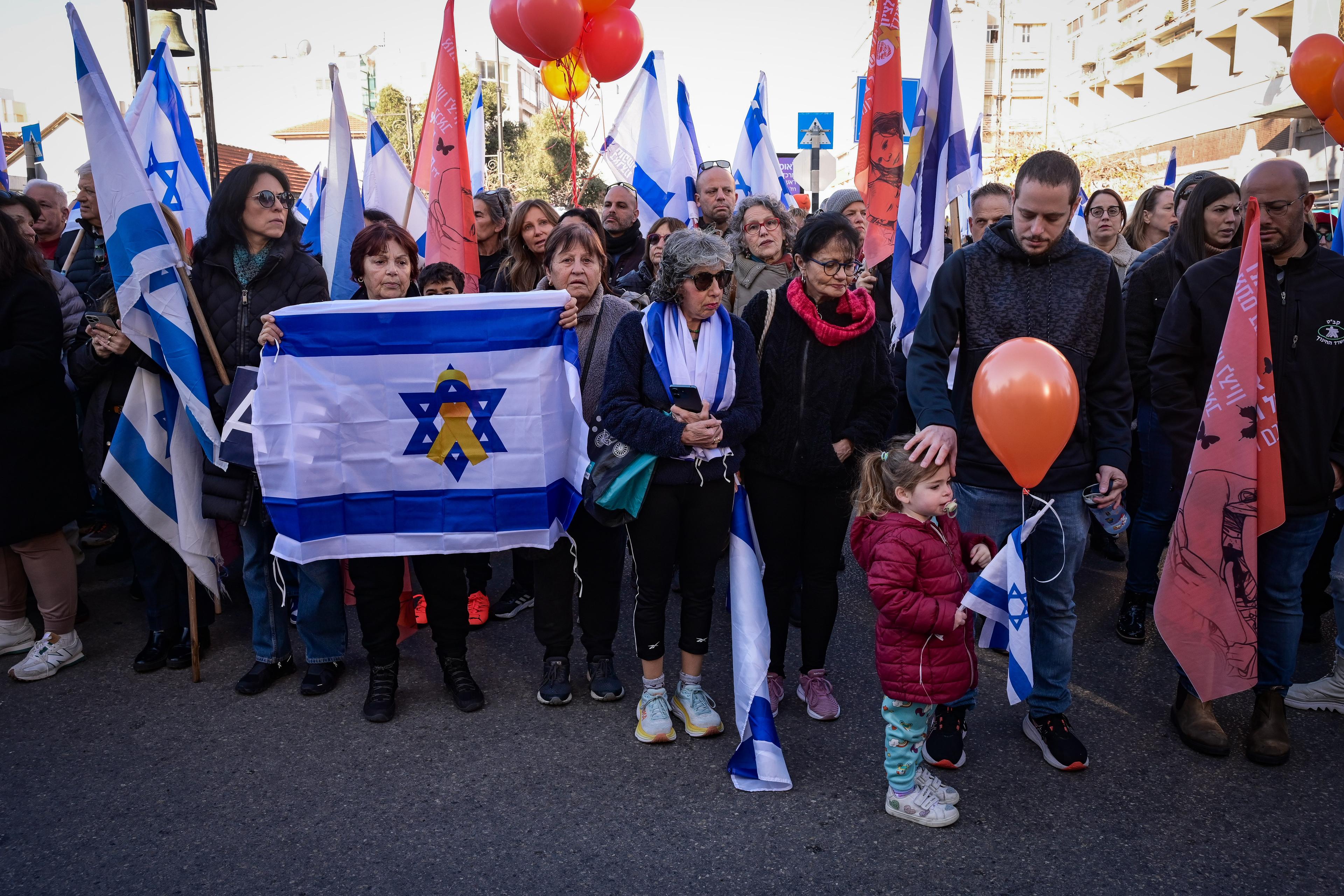People pay their respects during the funeral service of late Israeli hostages Shiri Bibas and her children Ariel and Kfir in Rishon LeZion, February 26, 2025. 