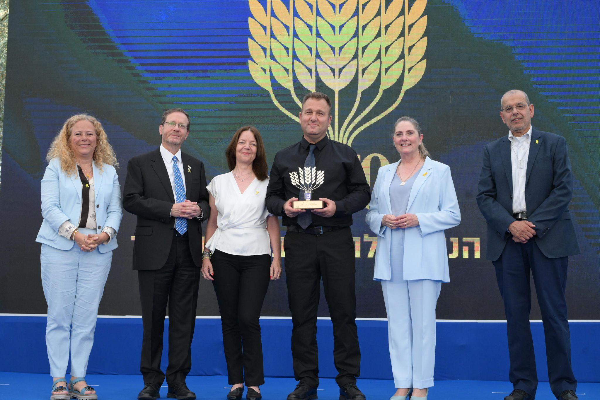 Receiving an award from President Herzog Receiving an award from President Herzog