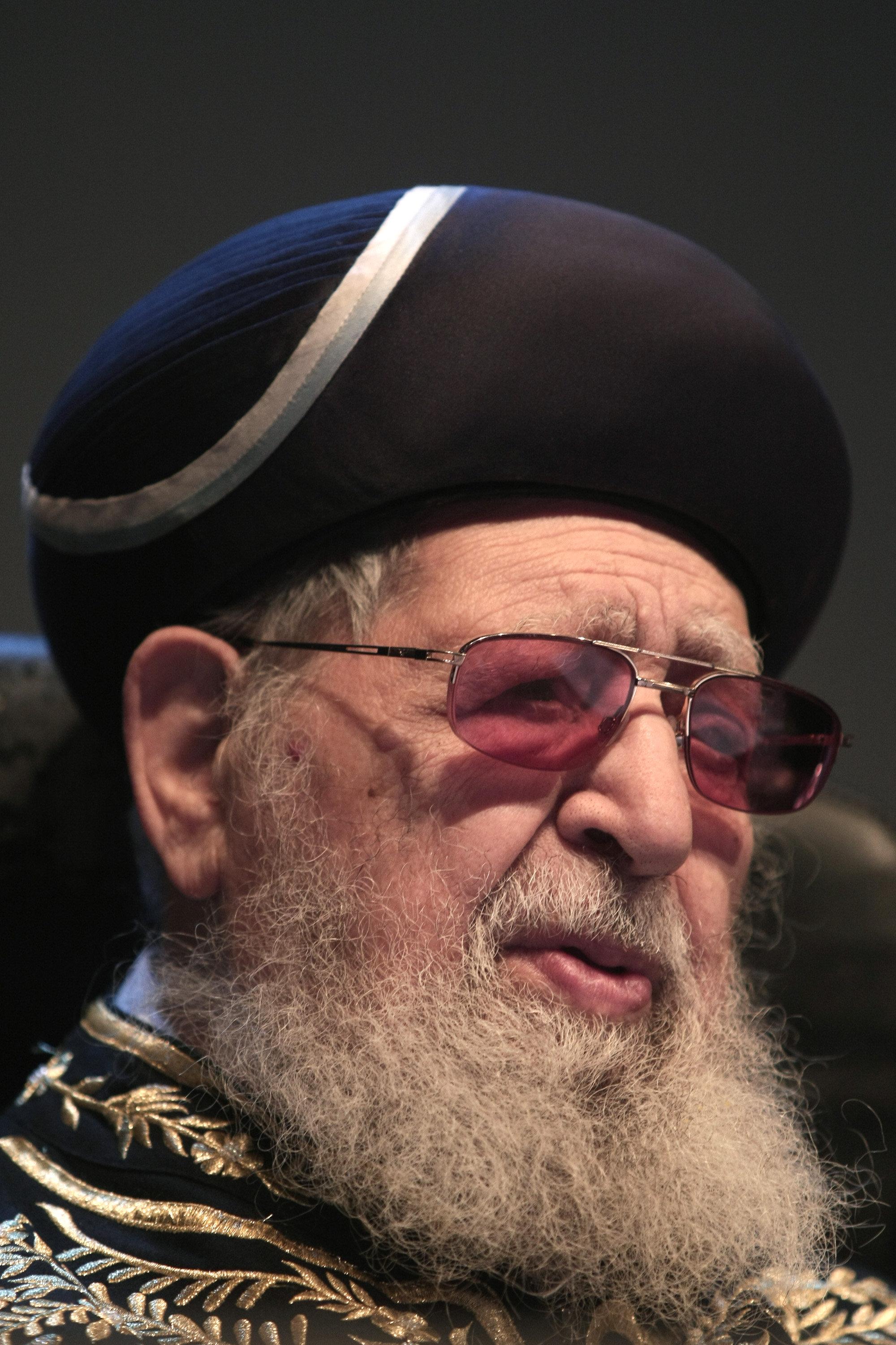 Shas spirtual leader Rabbi Ovadia Yosef looks on as Ultra Orthodox Jewish men gather for a conference at the Jerusalem's International Convention Center
