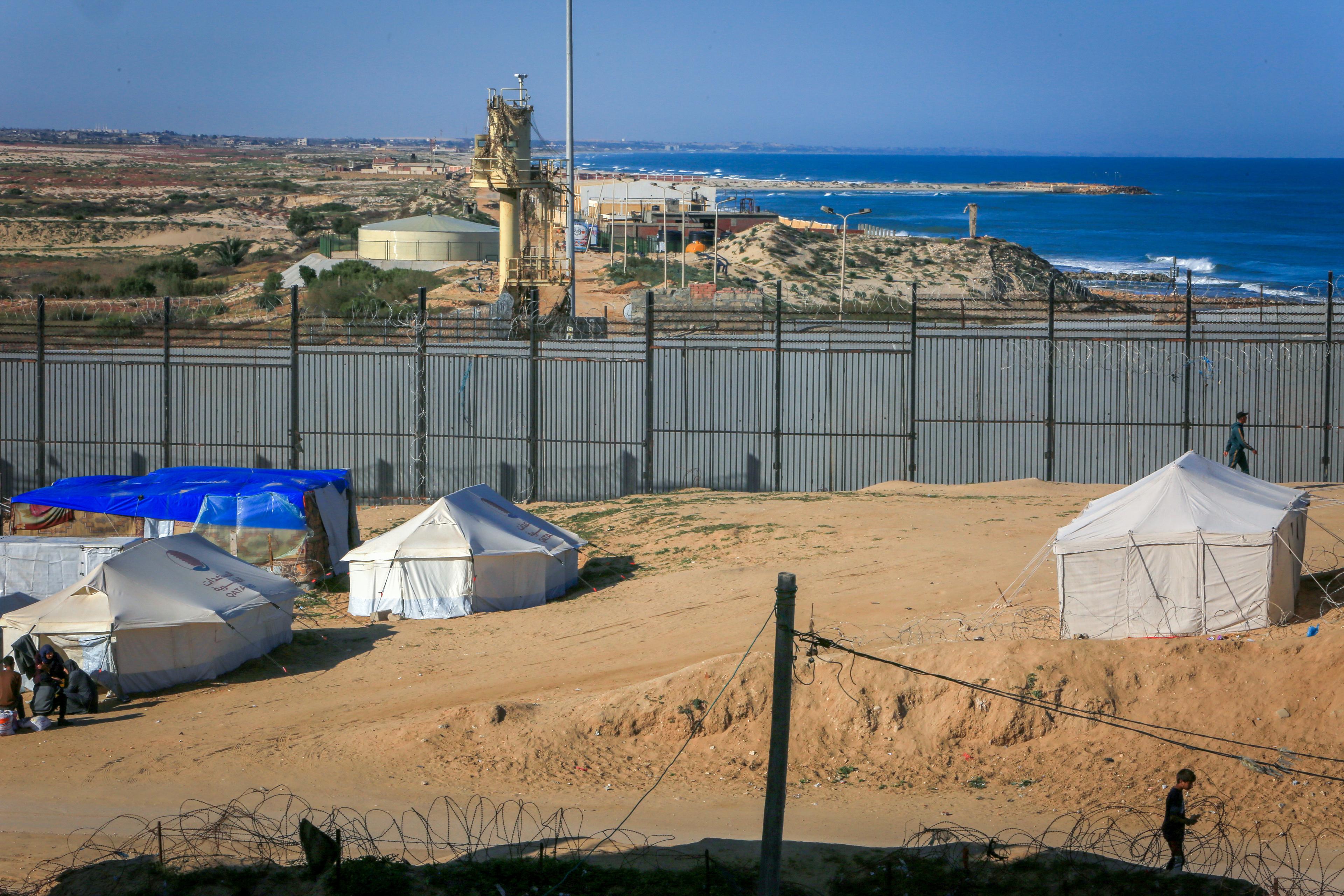 Displaced Palestinians pitch their tents next to the Egyptian border with the city of Rafah in the southern Gaza Strip