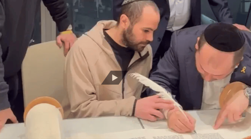 Yarden Bibas writing a Torah scroll