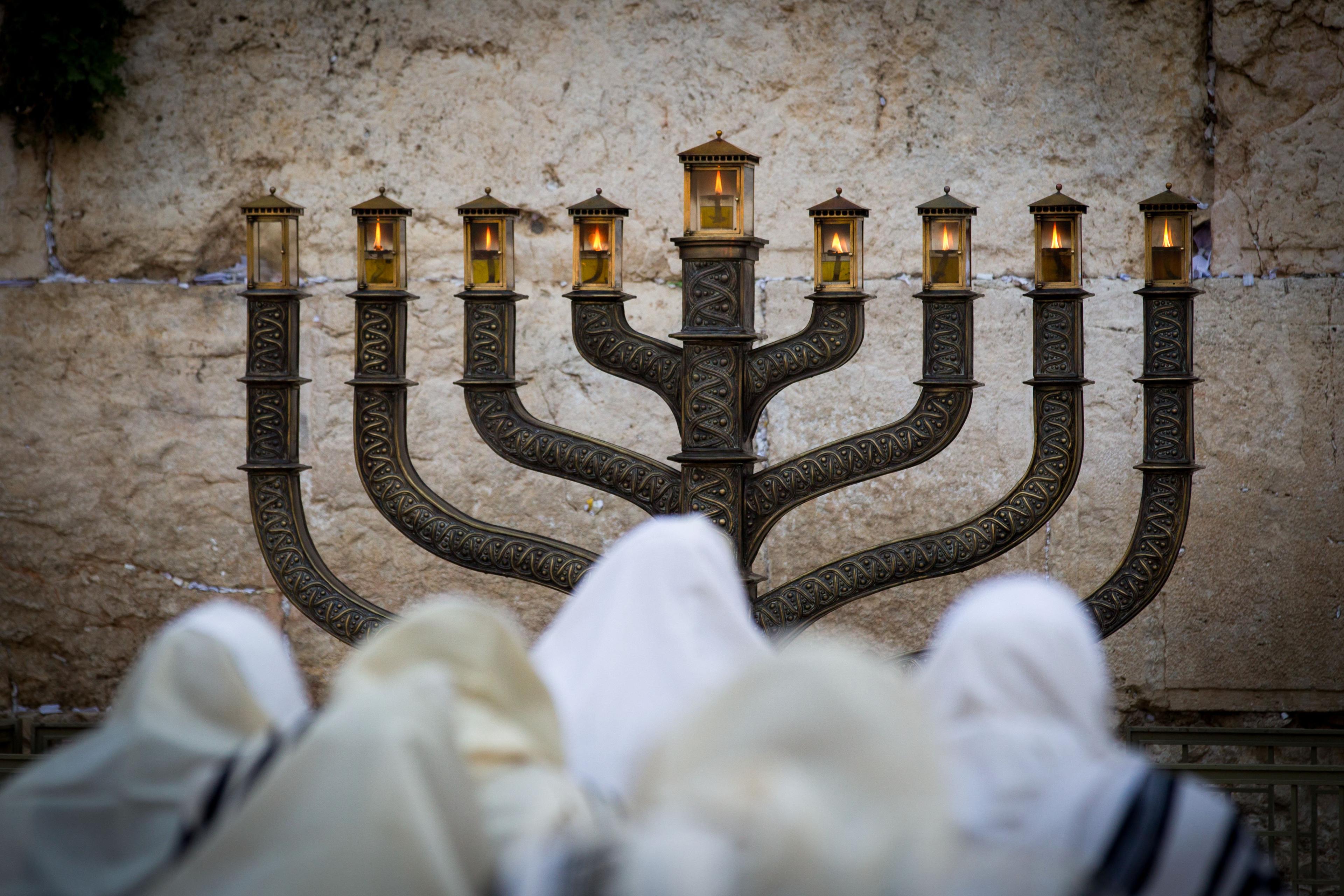Ultra Orthodox Jews pray in front of the Menorah at the Western Wall 