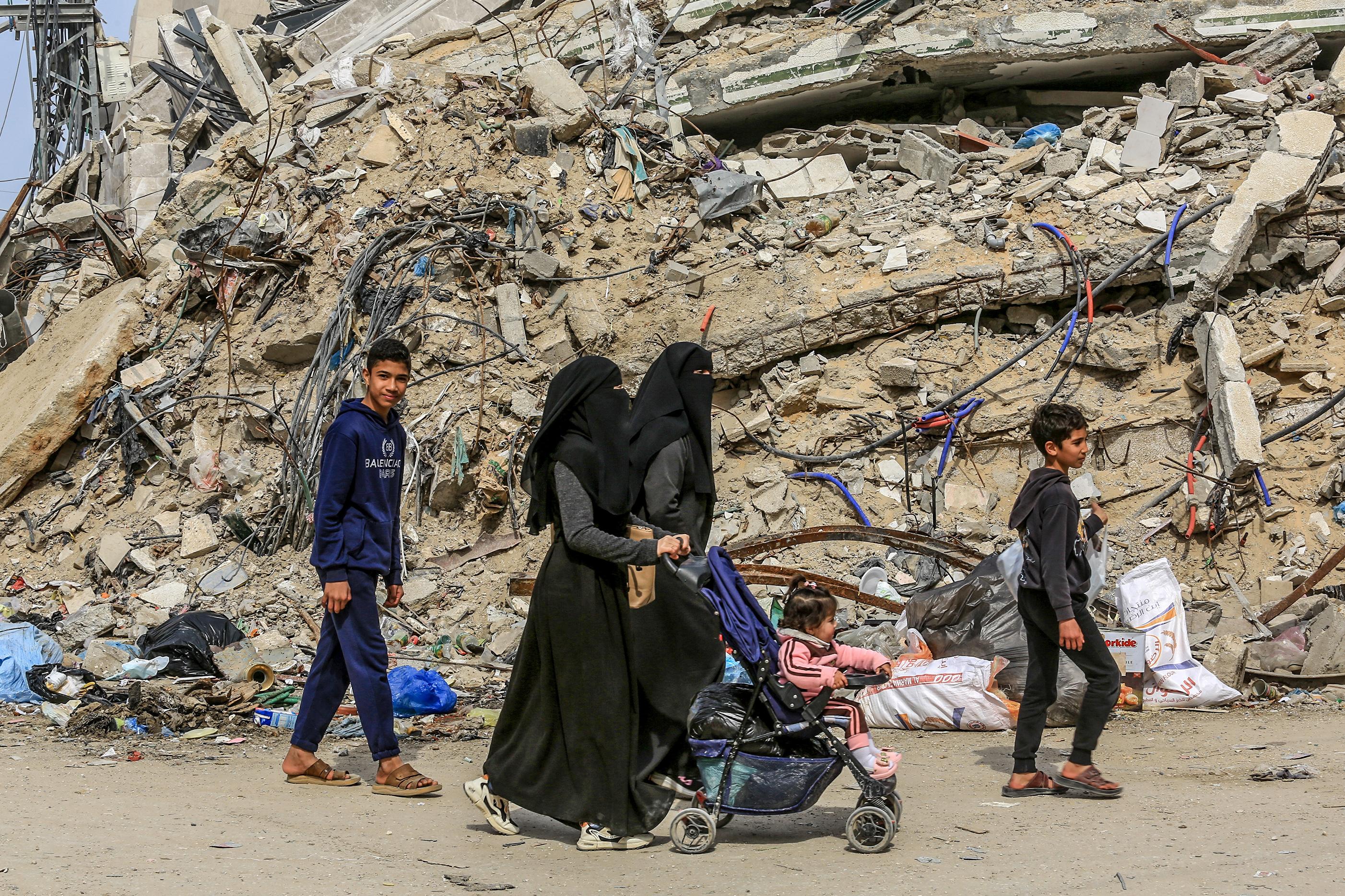 Palestinians among the ruins in Gaza.
