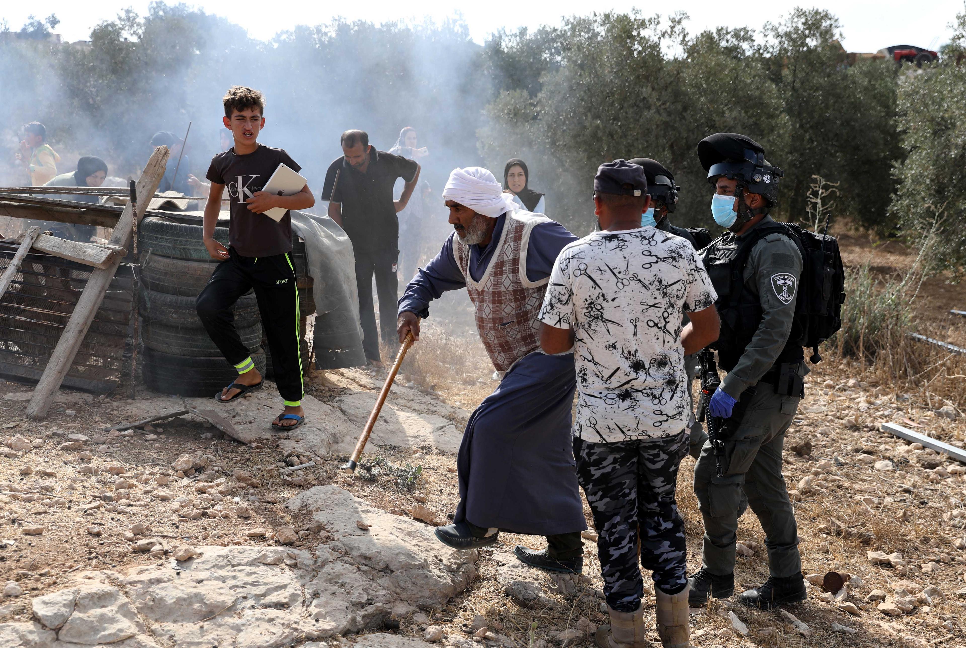 Israeli security forces argue with Palestinians as they arrive to demolish a house that was built without a permit in Yatta, Judea and Samaria