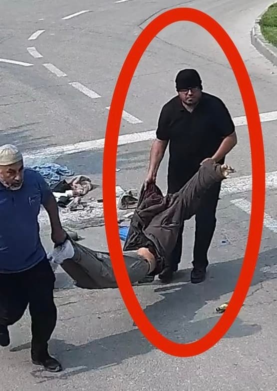 Mohammad Abu Ittiwi, an employee of UNRWA, carrying the body of Yonathan Samanero Mohammad Abu Ittiwi, an employee of UNRWA, carrying the body of Yonathan Samanero