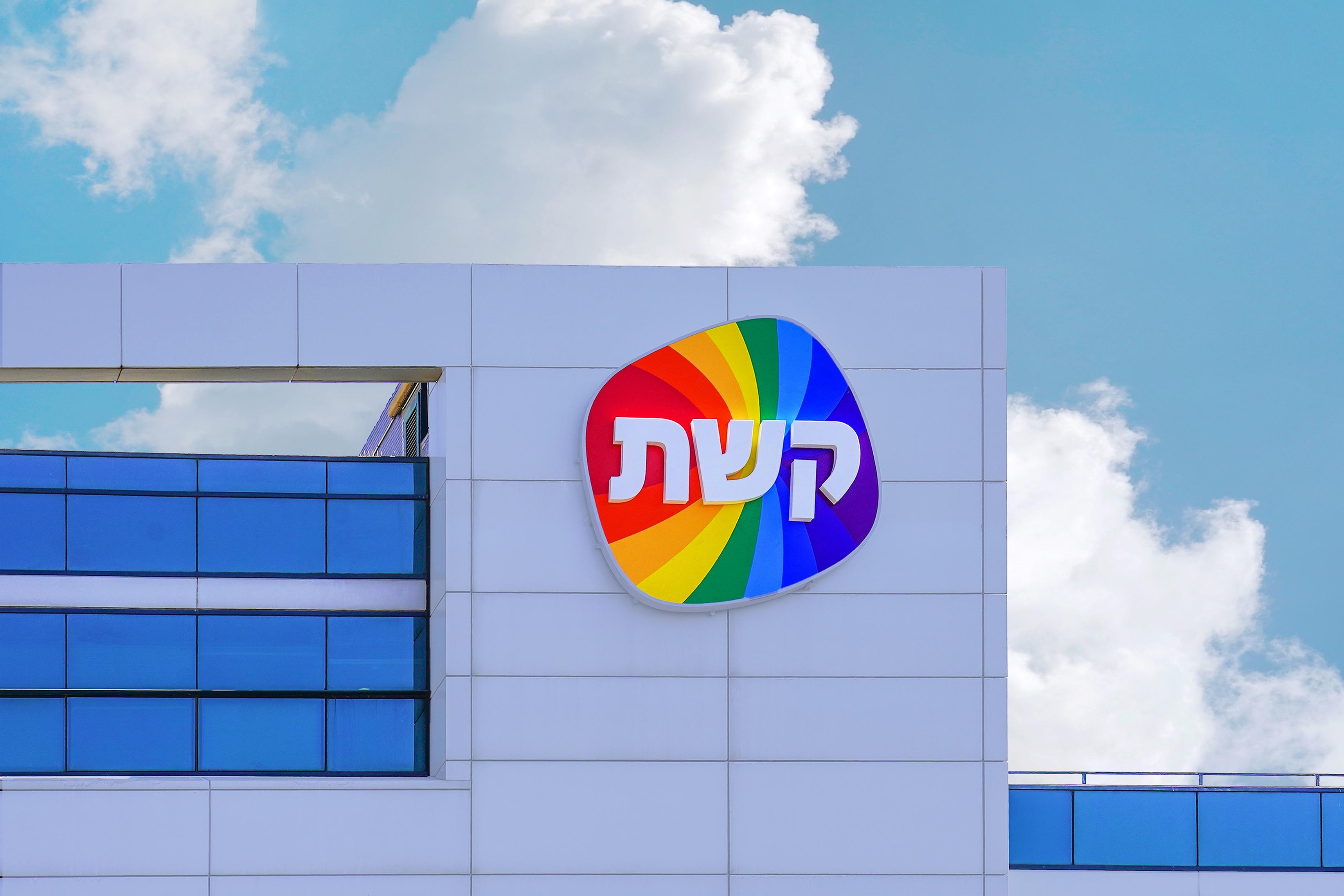 A sign with a Hebrew logo Keshet over on building TV Channel 12