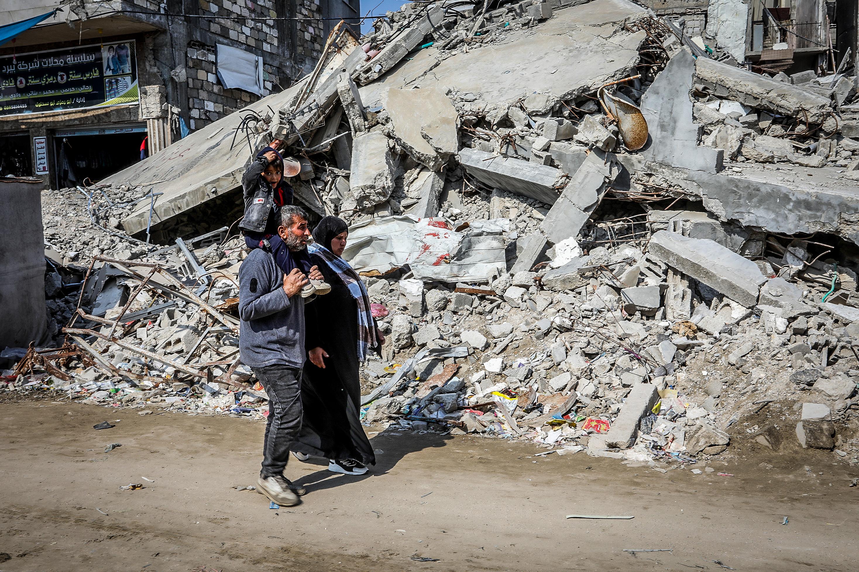 Palestinians in the ruins of Gaza.
