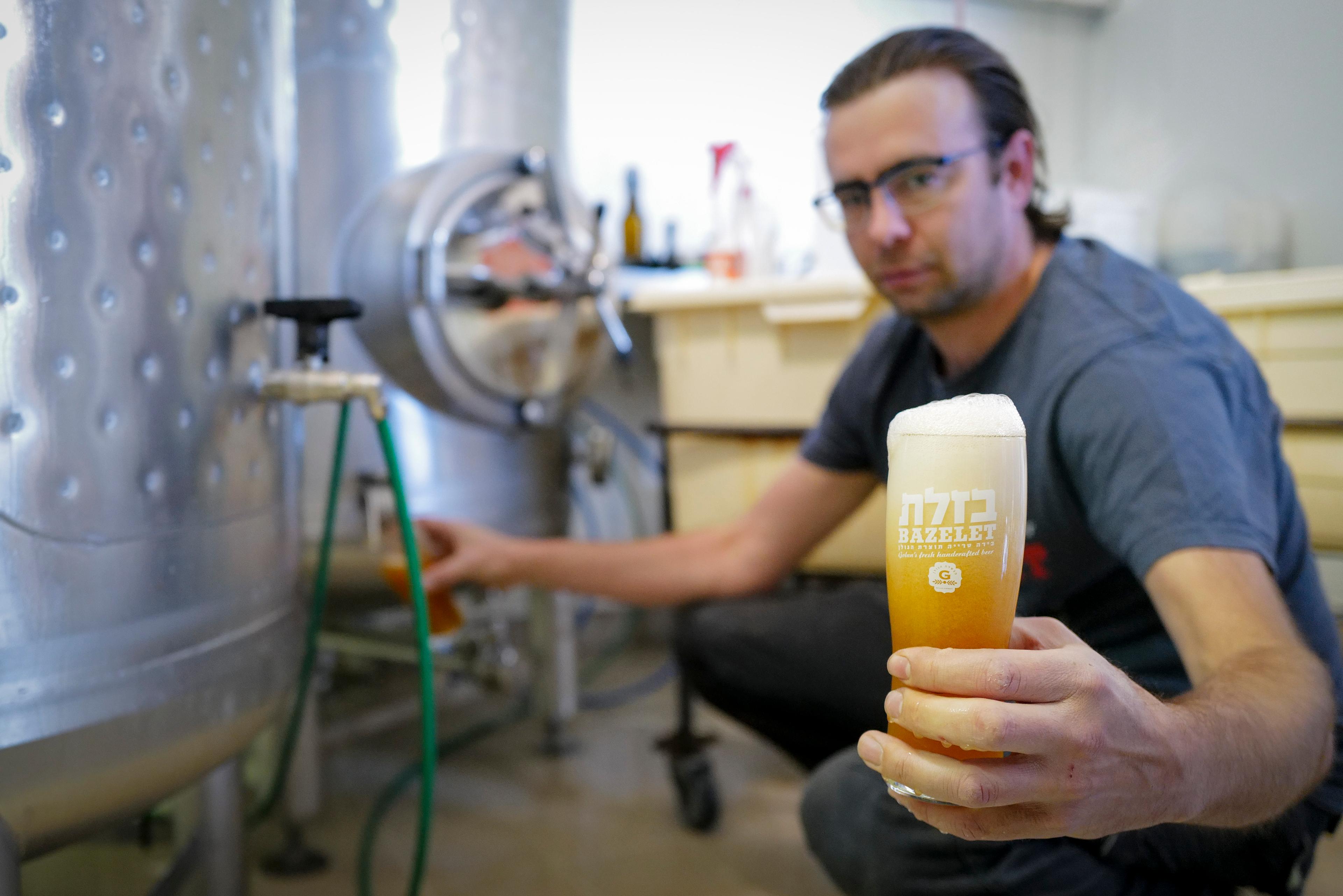 The Golan first Premium Craft Beer Brewery staff produce the Bazelet beer brand to supply the demand for the Jewish Festival of Purim, Katsrin Industrial Zone, Golan Heights on March 13, 2025. 