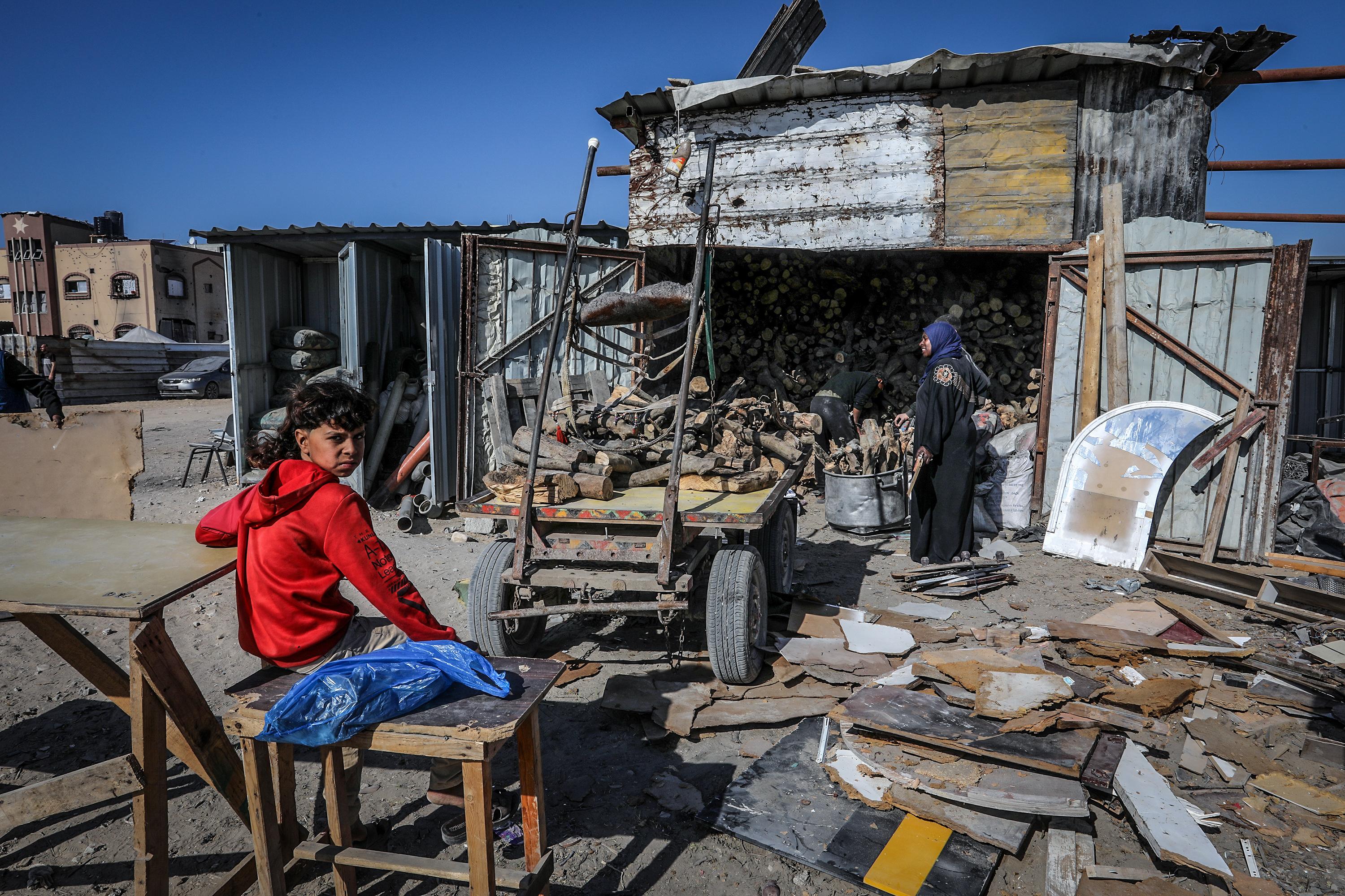 Palestinians sell firewood for cooking in Khan Yunis, in the southern Gaza Strip, due to a lack of cooking gas, March 12, 2025.