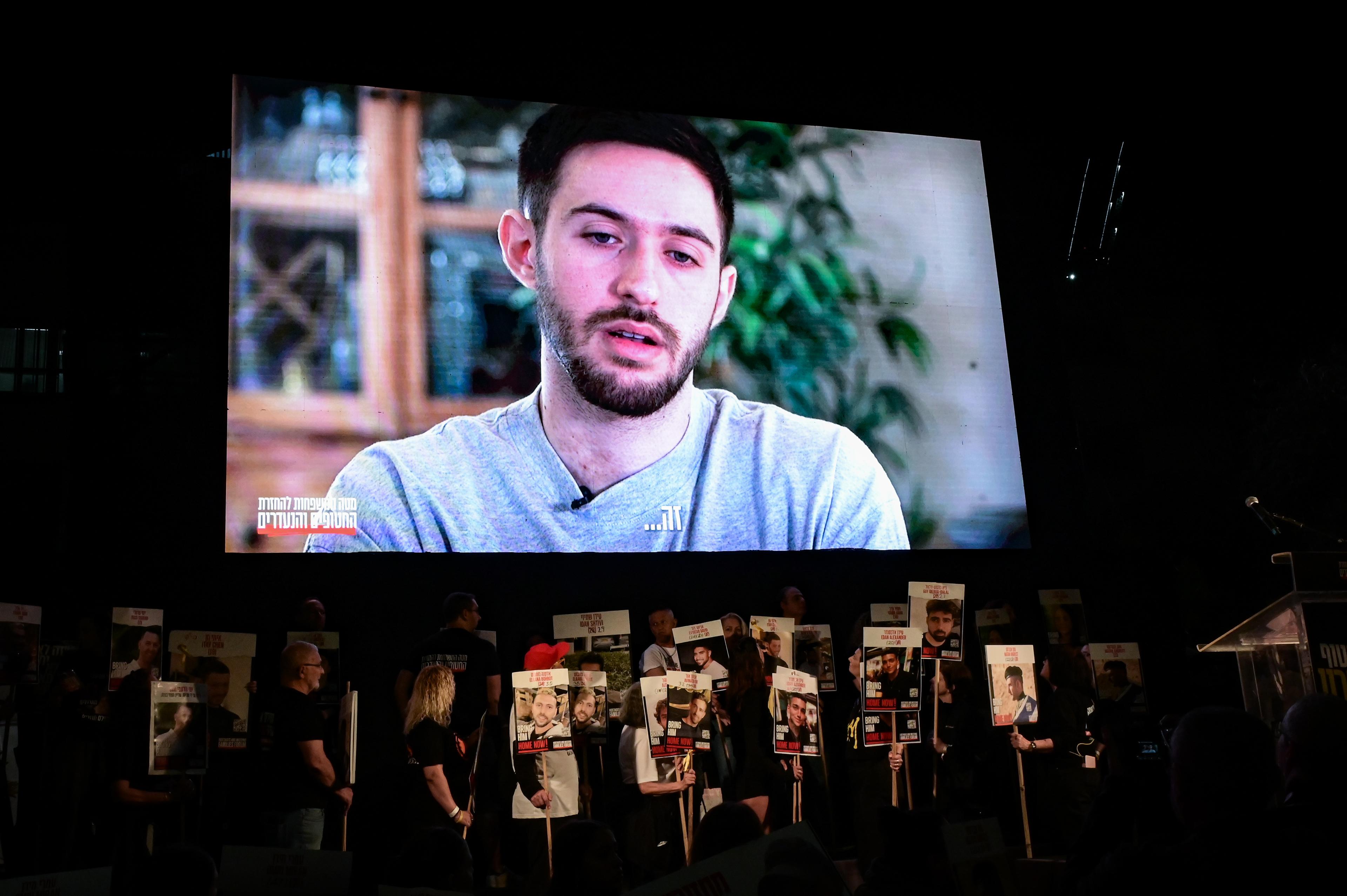 Former hostage Omer Shem Tov speaks on a screen during a rally calling for the release of Israelis held hostage by Hamas terrorists in Gaza, at "Hostage Square" in Tel Aviv, March 15, 2025. 