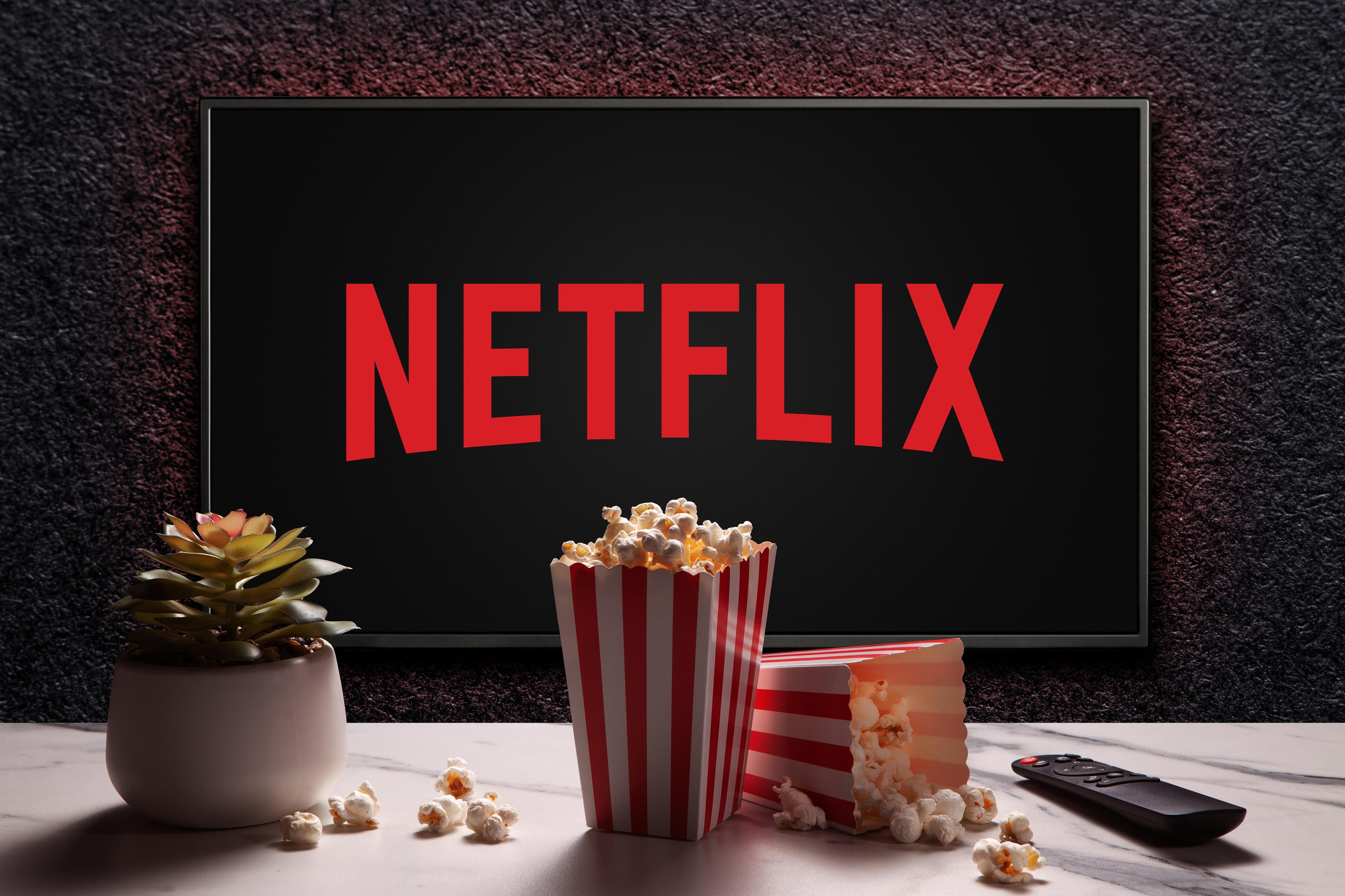  Netflix logo on TV with popcorn boxes, remote control