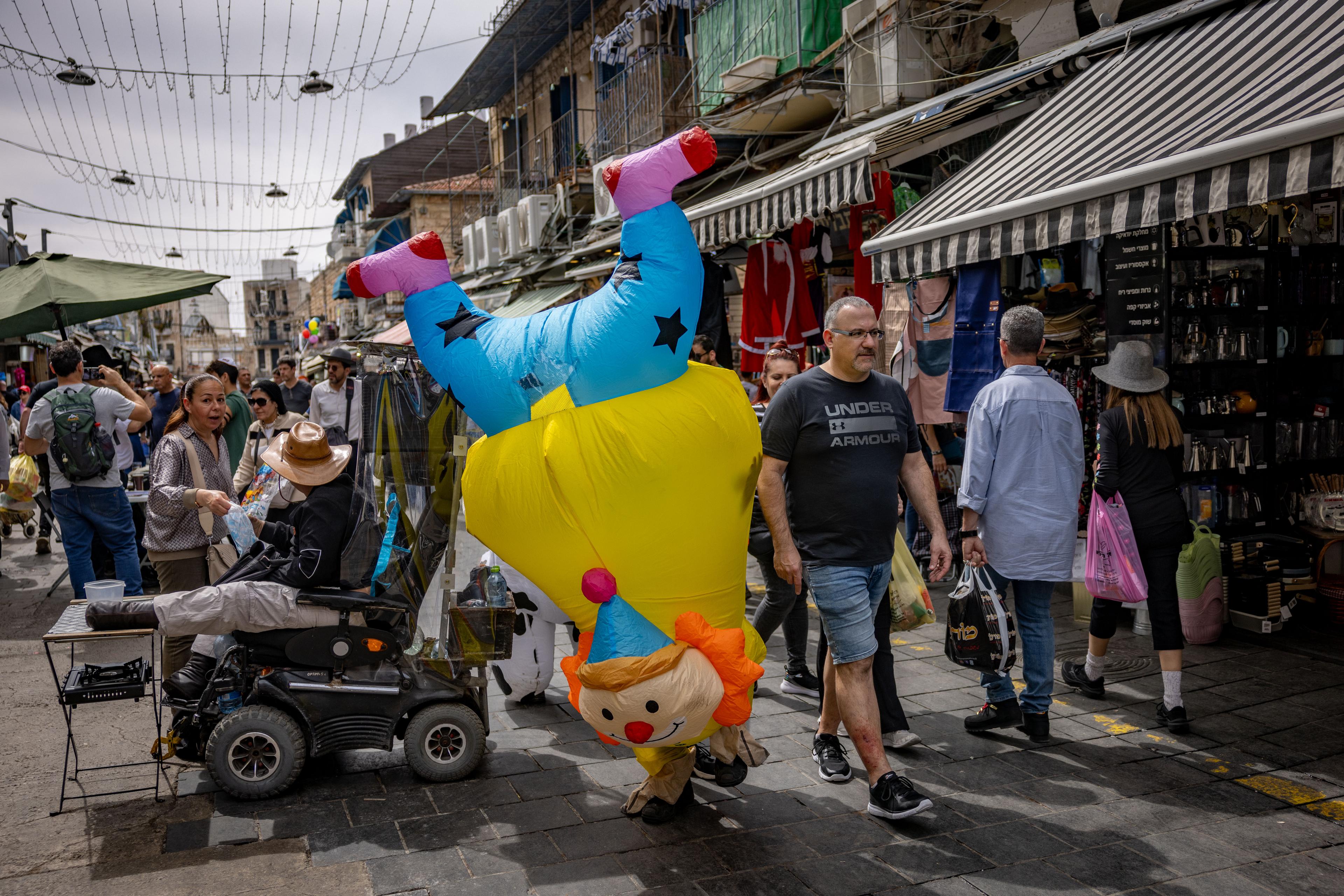 Israelis dressed up in custumes walking at the Mahane Yehuda market in Jerusalem, during the Jewish holiday of Purim, March 14, 2025. Israelis dressed up in custumes walking at the Mahane Yehuda market in Jerusalem, during the Jewish holiday of Purim, March 14, 2025.