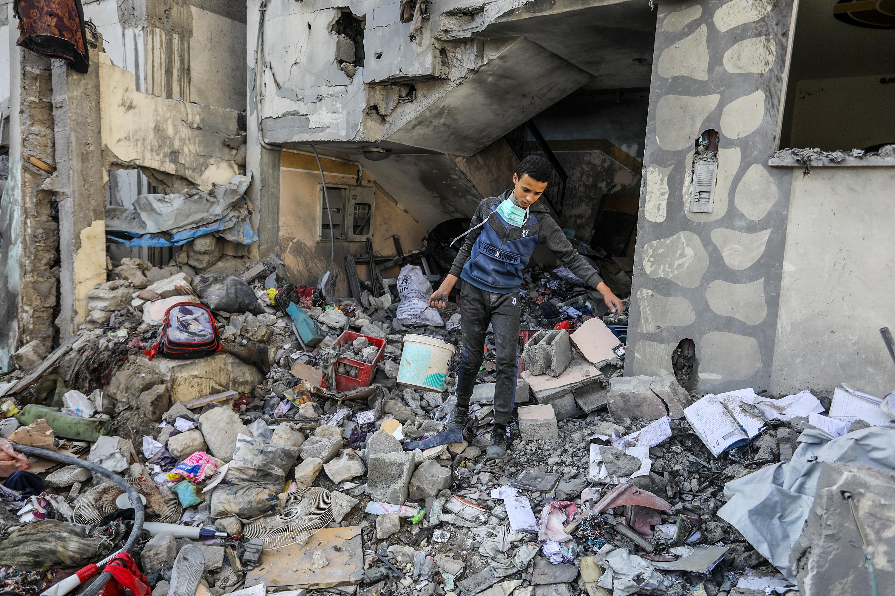Palestinians at the scene of an Israeli airstrike in Khan Yunis, on March 18, 2025. 