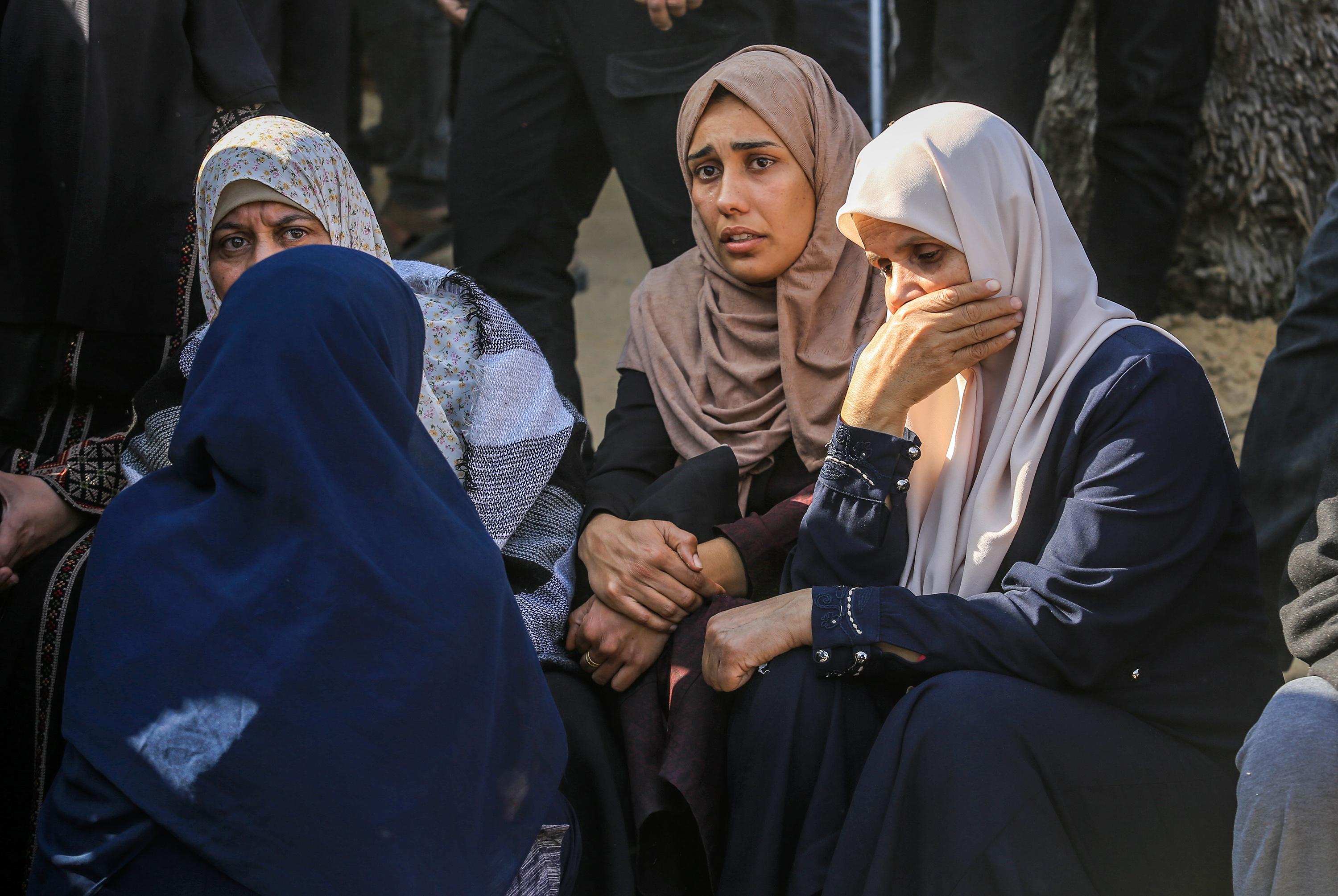 Palestinians mourn the death of Palestinians killed in an Israeli air strike outside the Nasser Hospital in Khan Yunis, in the southern Gaza Strip, March 18, 2025. 