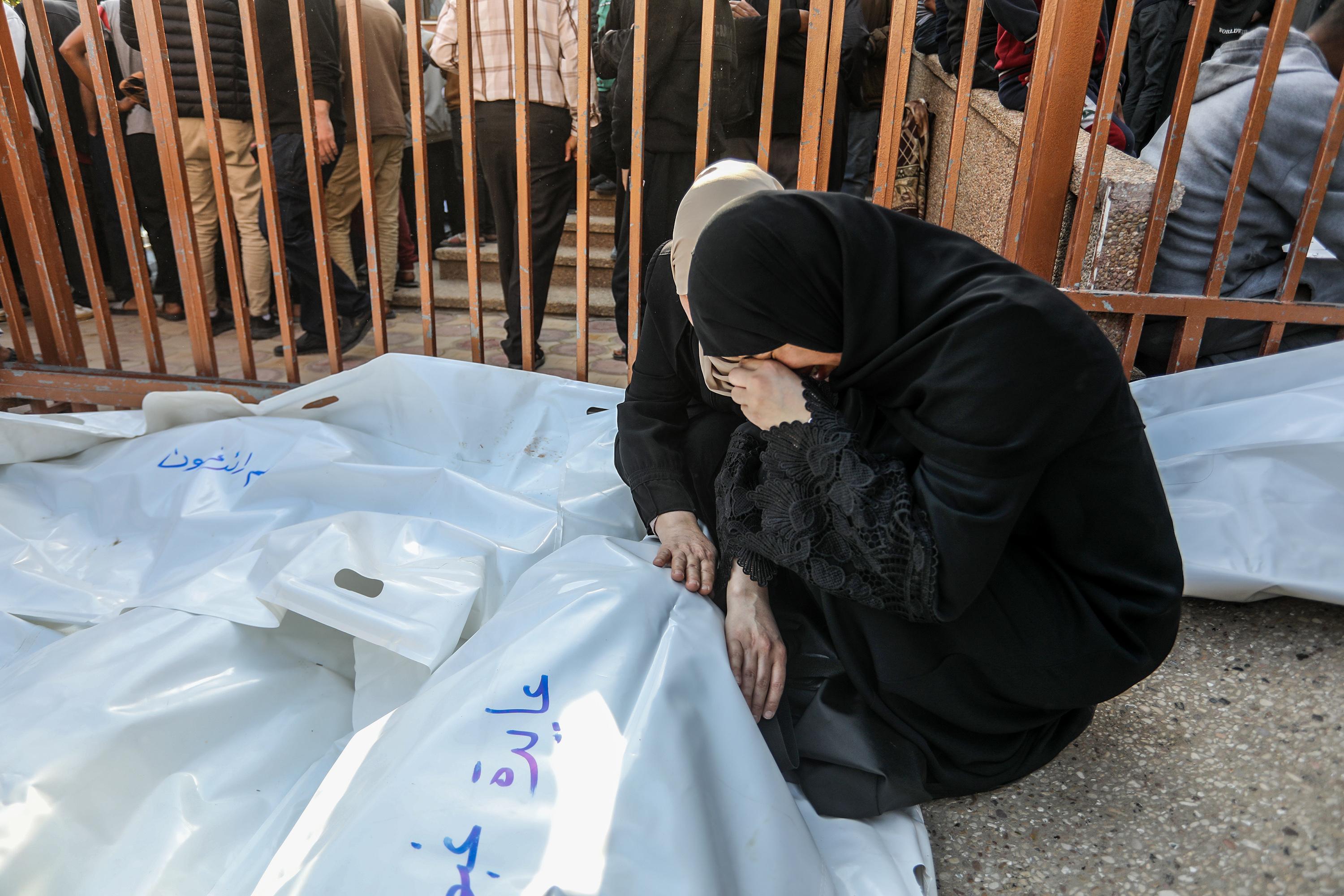 Palestinians mourn the death of Palestinians killed in an Israeli air strike outside the Nasser Hospital in Khan Yunis, in the southern Gaza Strip, March 18, 2025. 