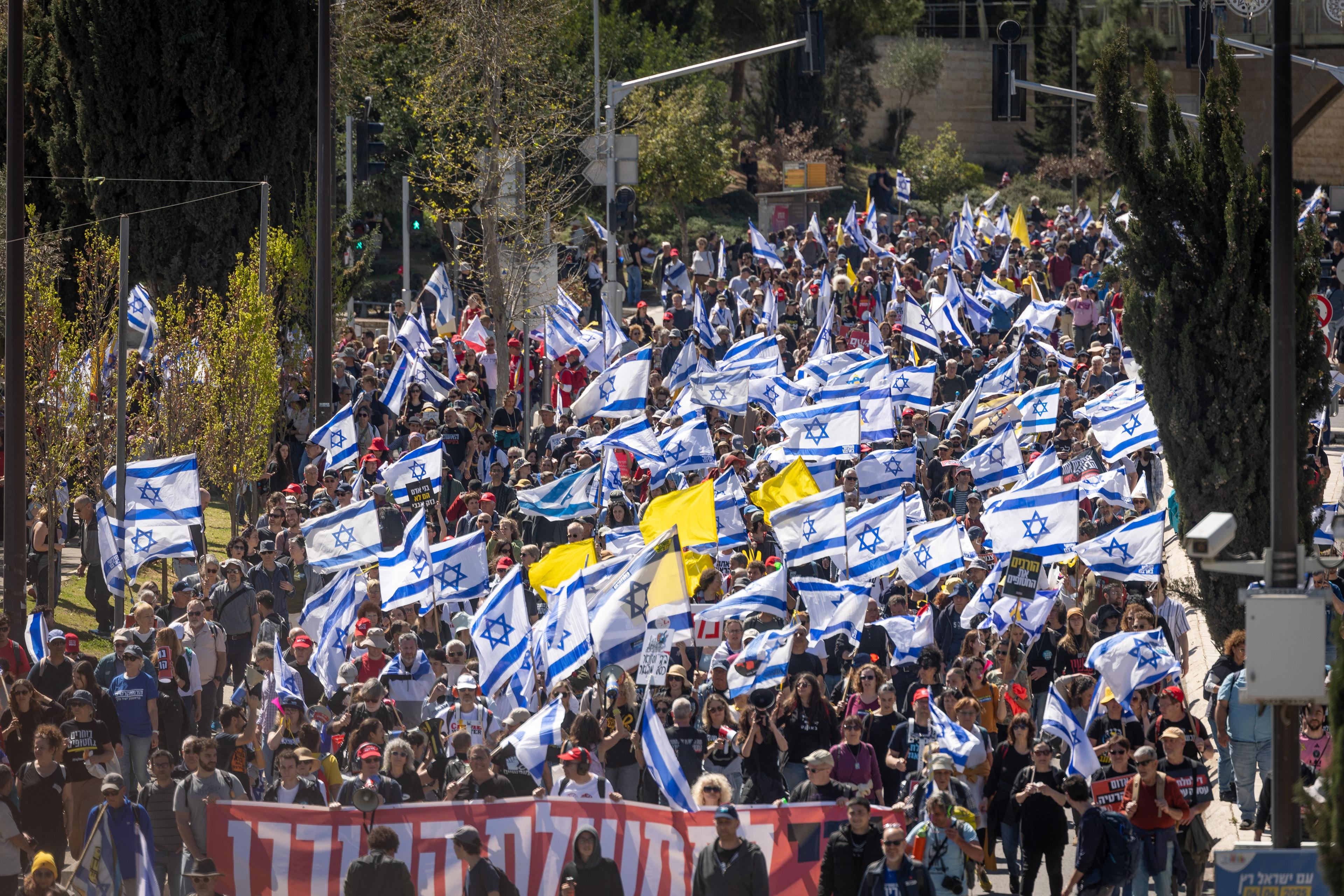 Israelis attend a protest march against the decision of Israeli prime minister Benjamin Netanyahu to fire head of Shin Bat Ronen Bar, in Jerusalem. March 19, 2025. 