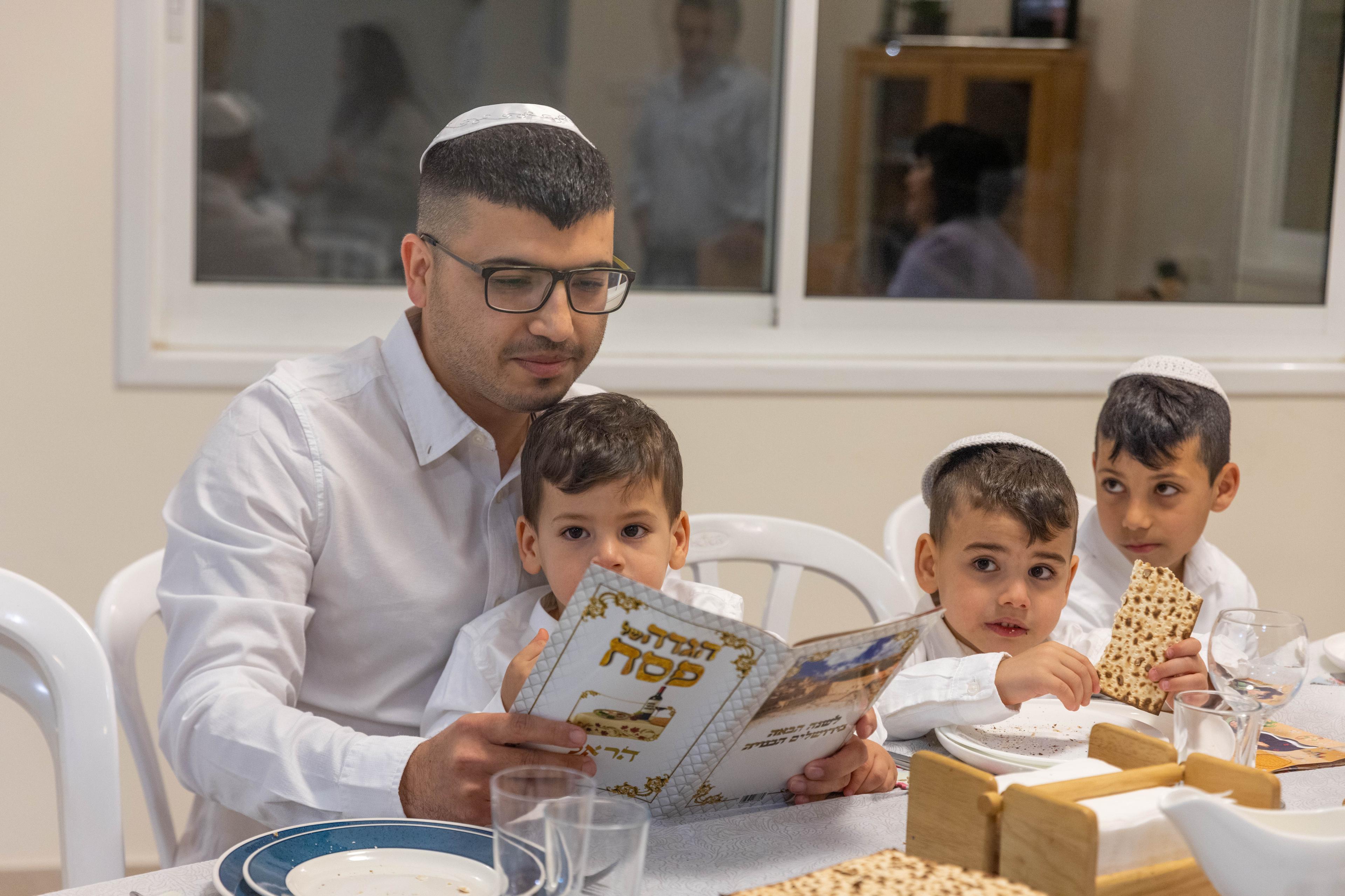 A Jewish family seen during the "Passover Seder" on the first night of the 8-day long Jewish holiday of Passover, in Moshav Yashresh, on April 5, 2023.
