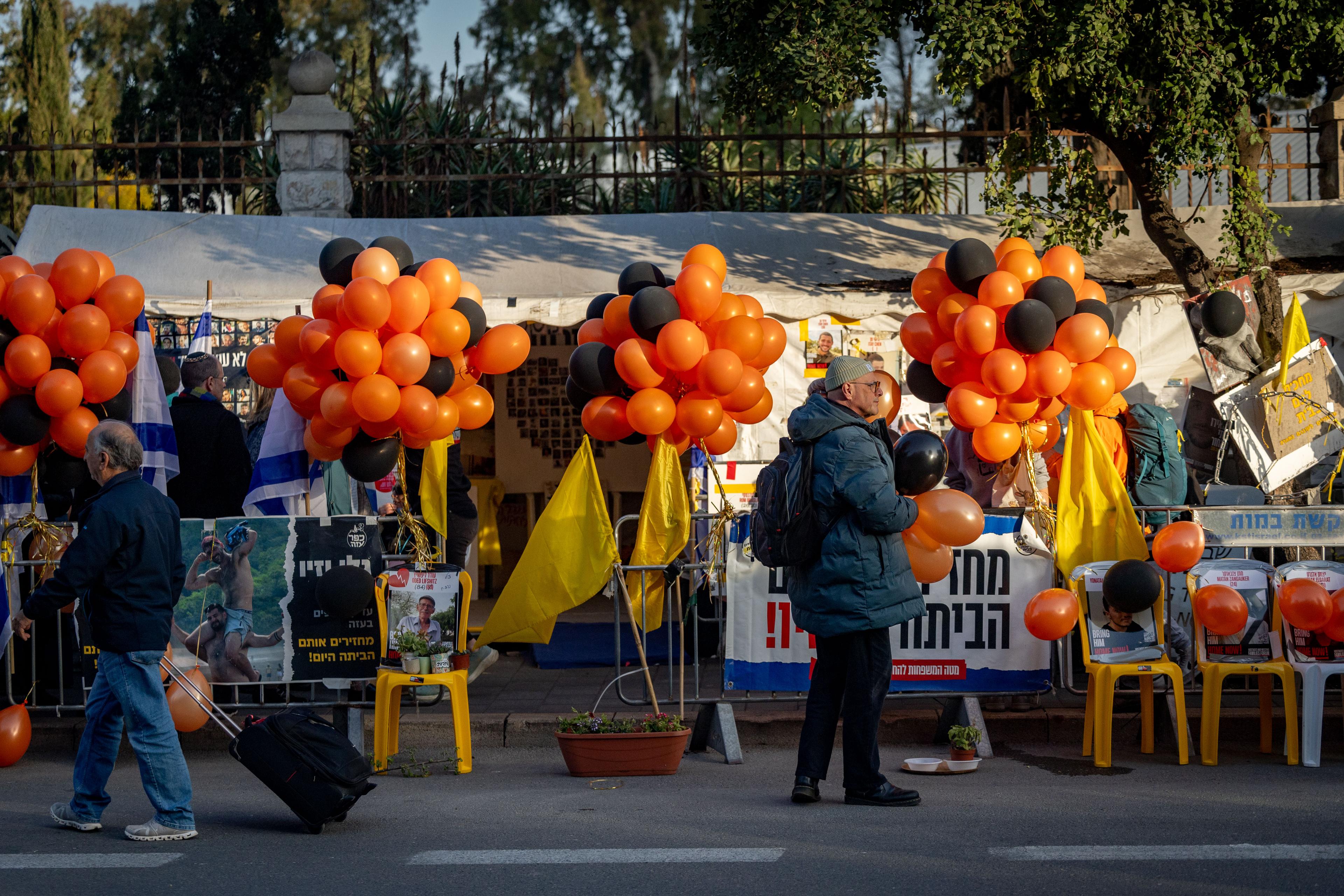 Israelis holding black and orange balloons during a memorial ceremony for late Israeli hostages Shiri Bibas and her children Ariel and Kfir in Jerusalem, February 26, 2025. 