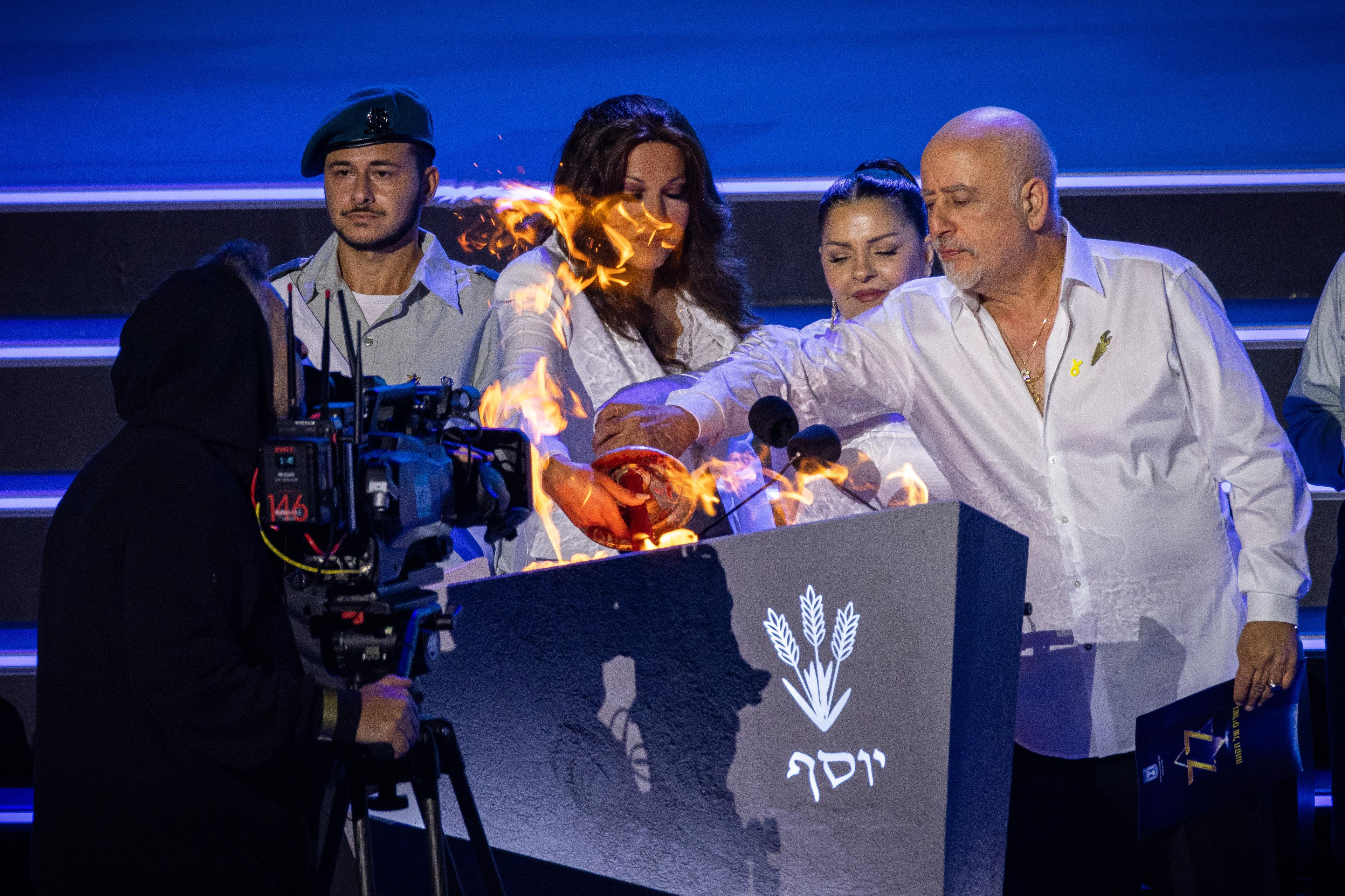 Israeli singers Zehava Ben, Micha Sheetrit and Dana International light the torch during the main rehearsal of the 77th anniversary Independence Day ceremony, held at Mount Herzl, Jerusalem, on April 28, 2025. 