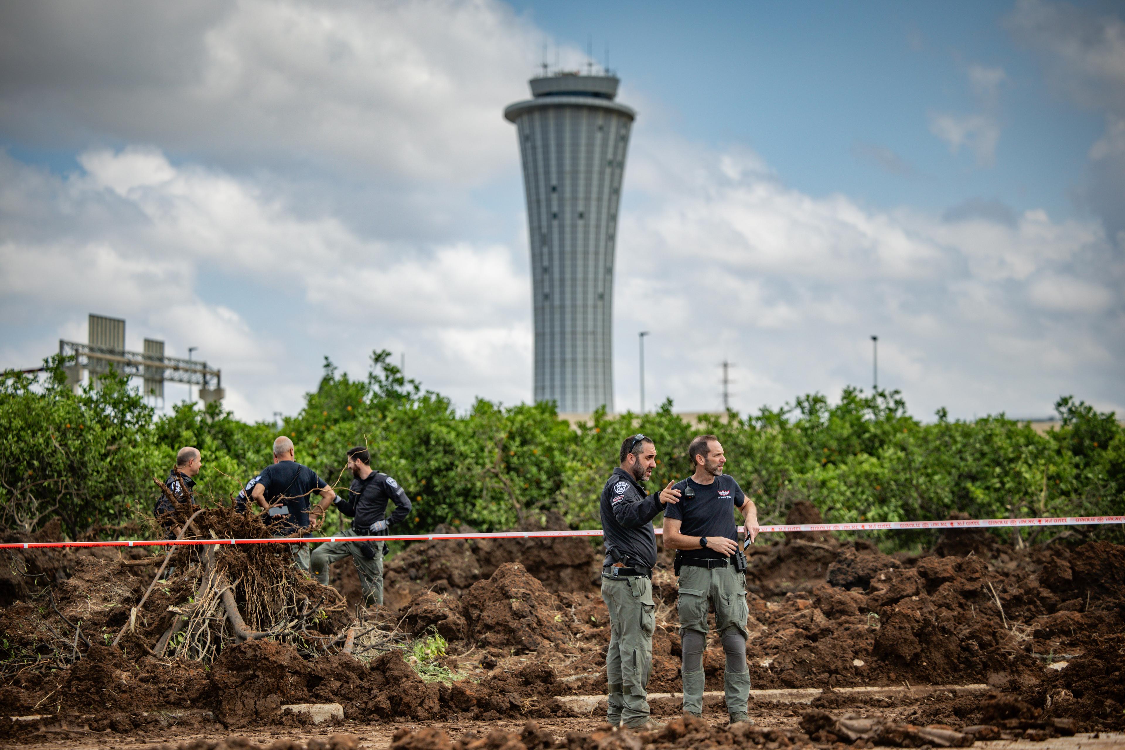 Israeli security forces at the site where a missile fired from Yemen hit an area of Ben Gurion Airport, May 4, 2025. 