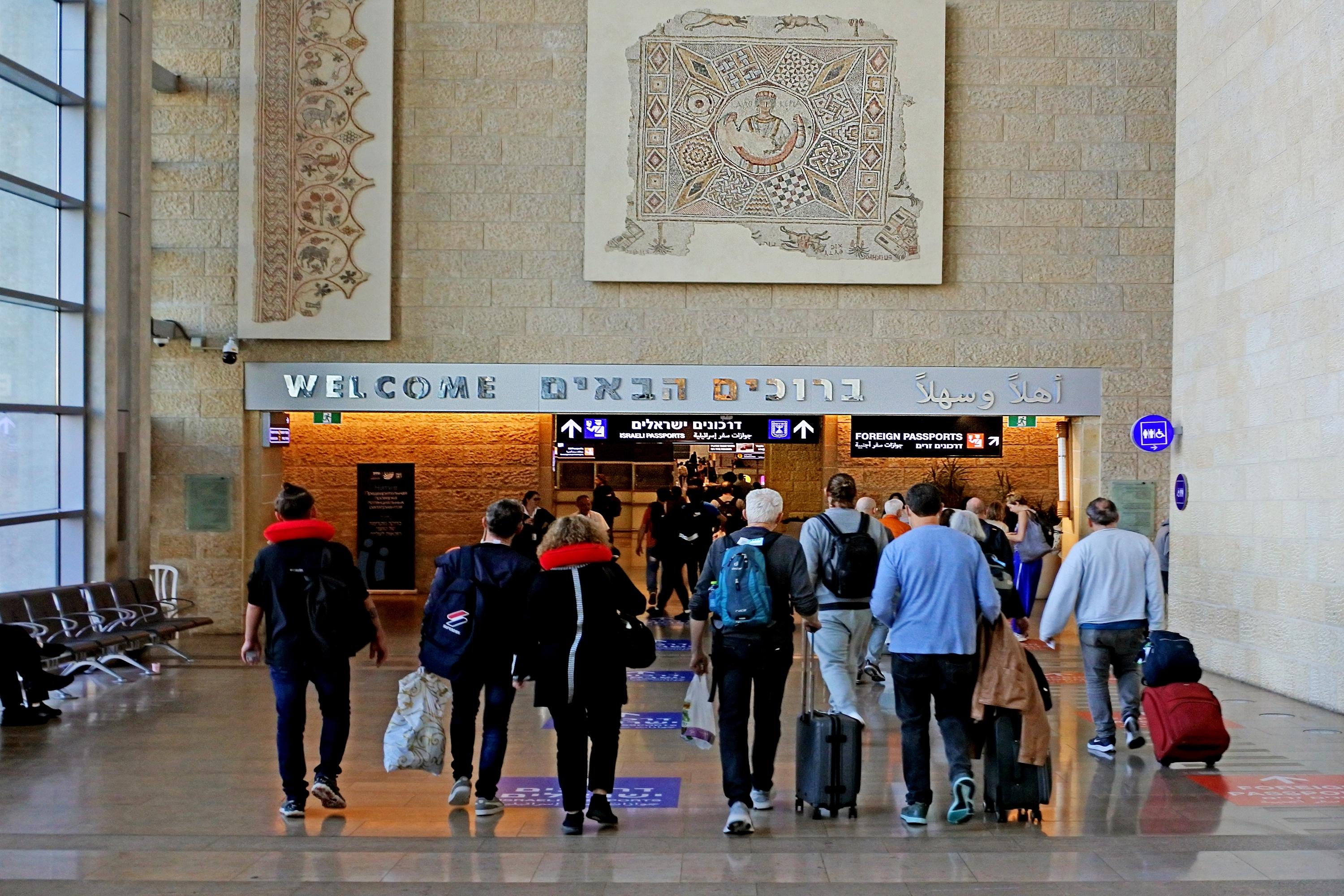 Welcome to Israel sign above passengers arriving to Israel at Ben Gurion Airport