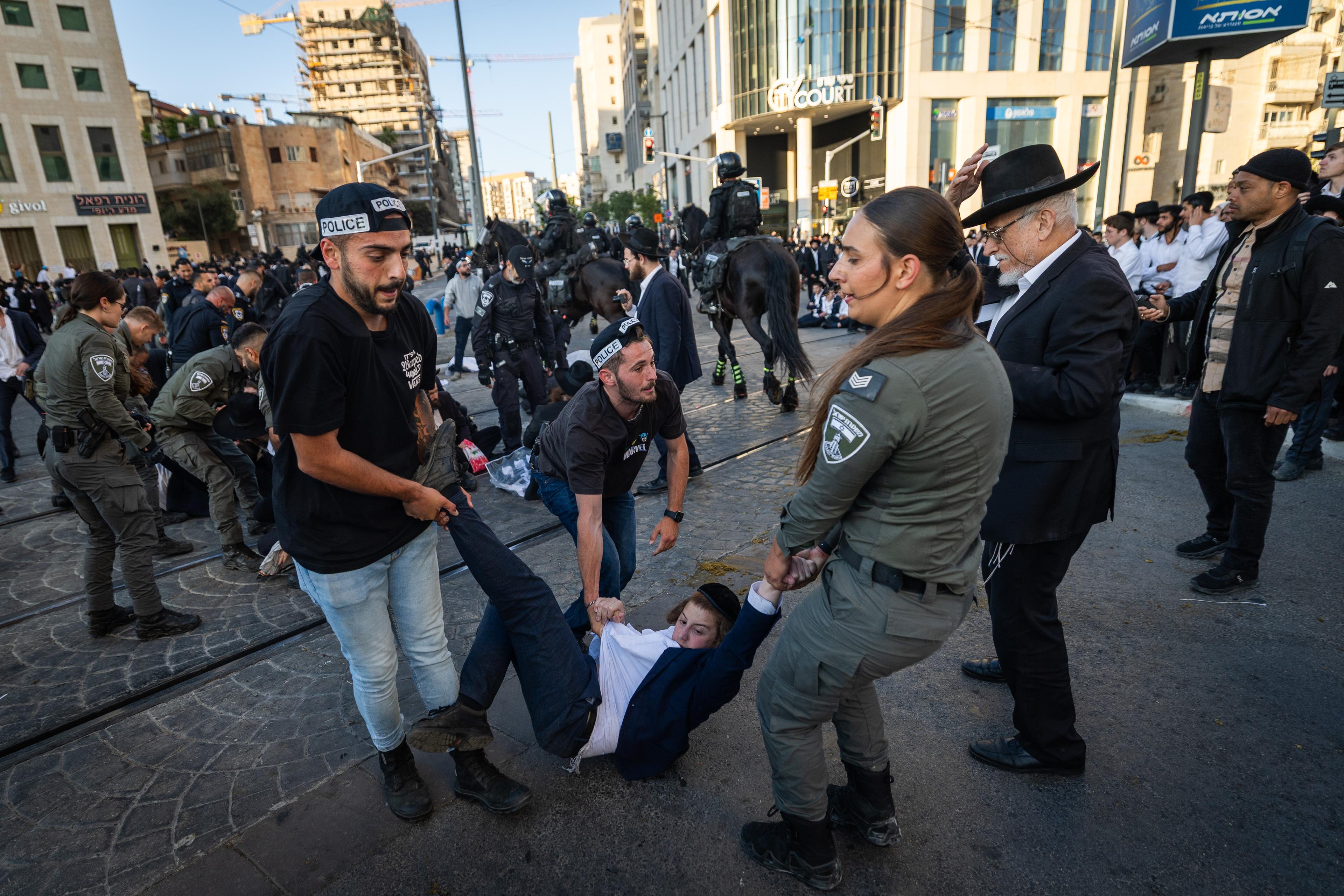 Ultra orthodox Jews protest and clash with police during a protest against the drafting of ultra orthodox jews to the Israeli army, outside a conference of ultra-Orthodox soldiers in Jerusalem, May 5, 2025. 