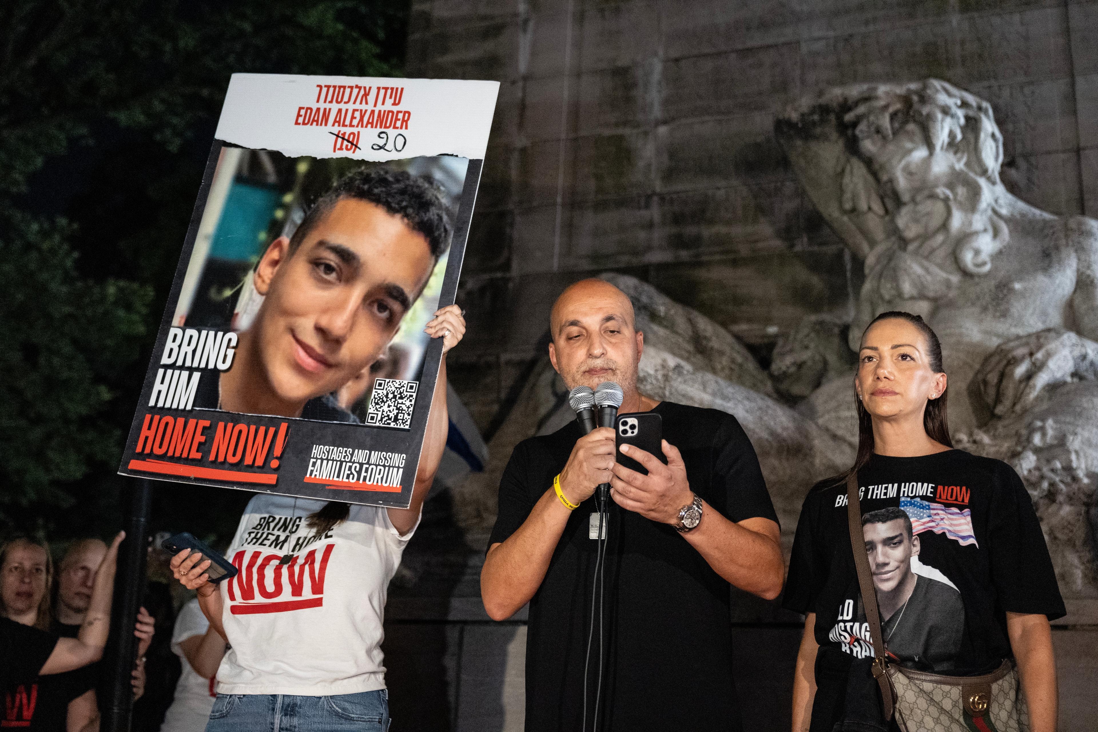 Adi Alexander speaks with Yael at his side, parents of Edan Alexander