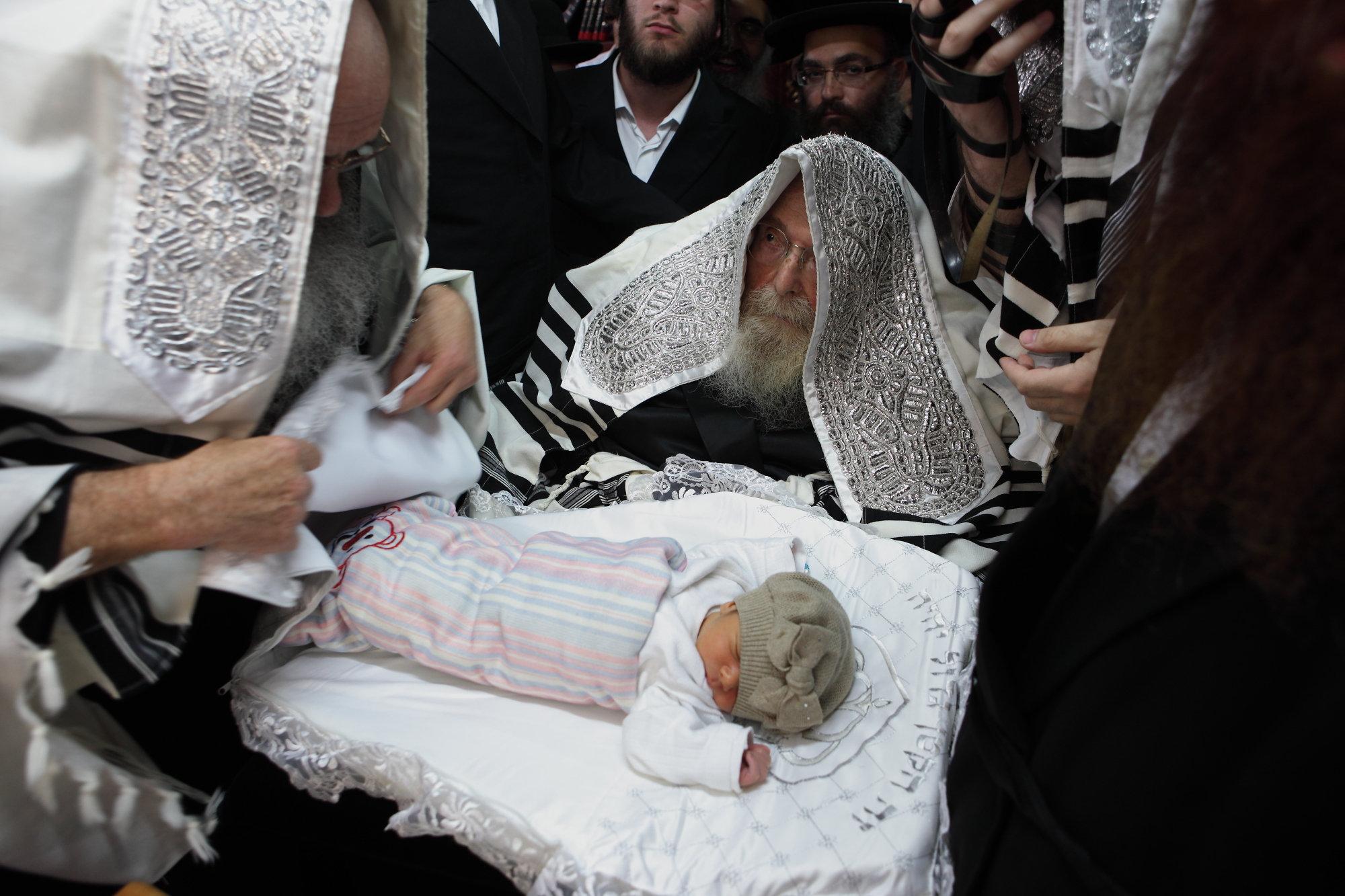 Illustration: The rebbe of Sadigora takes part at a circumcision ceremony in the city of Bnei Brak