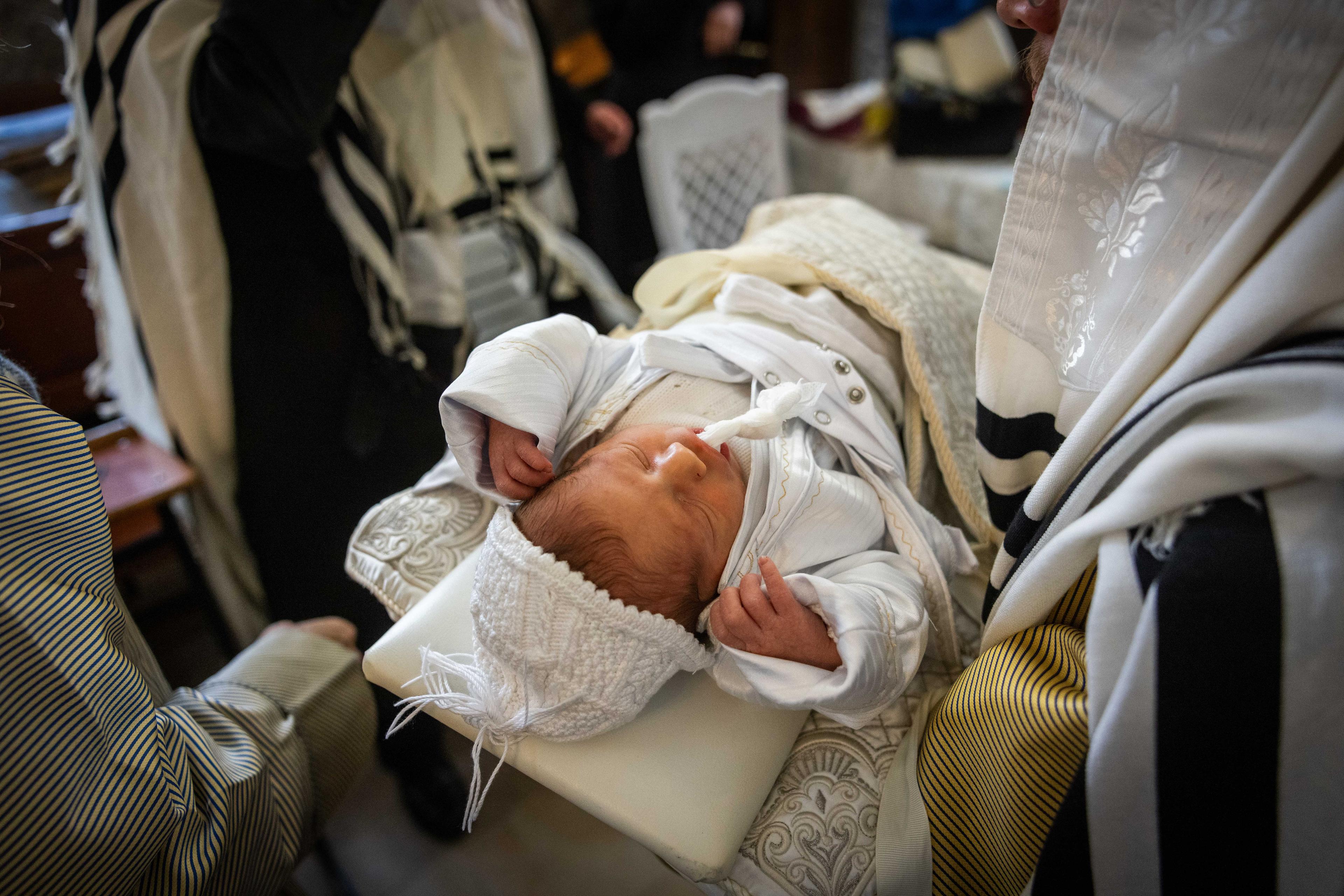 Rabbi's performing a Brit Milah, circumcision ceremony 