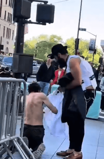 Chabad hassid giving the shirt off his back to a homeless man