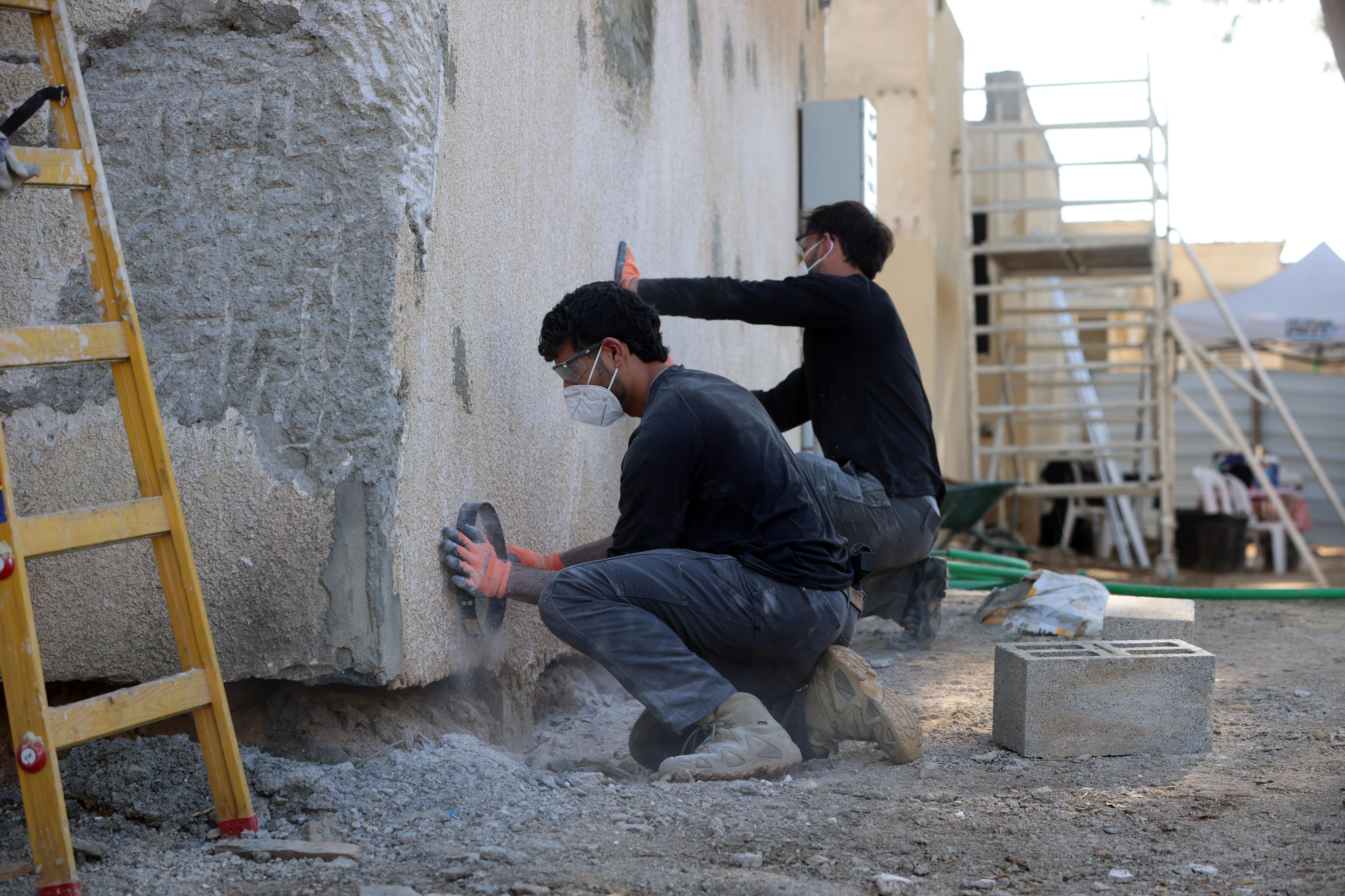 Volunteers renovating homes destroyed during the October 7 massacre, in Kibbutz Kfar Aza, December 2, 2024. 