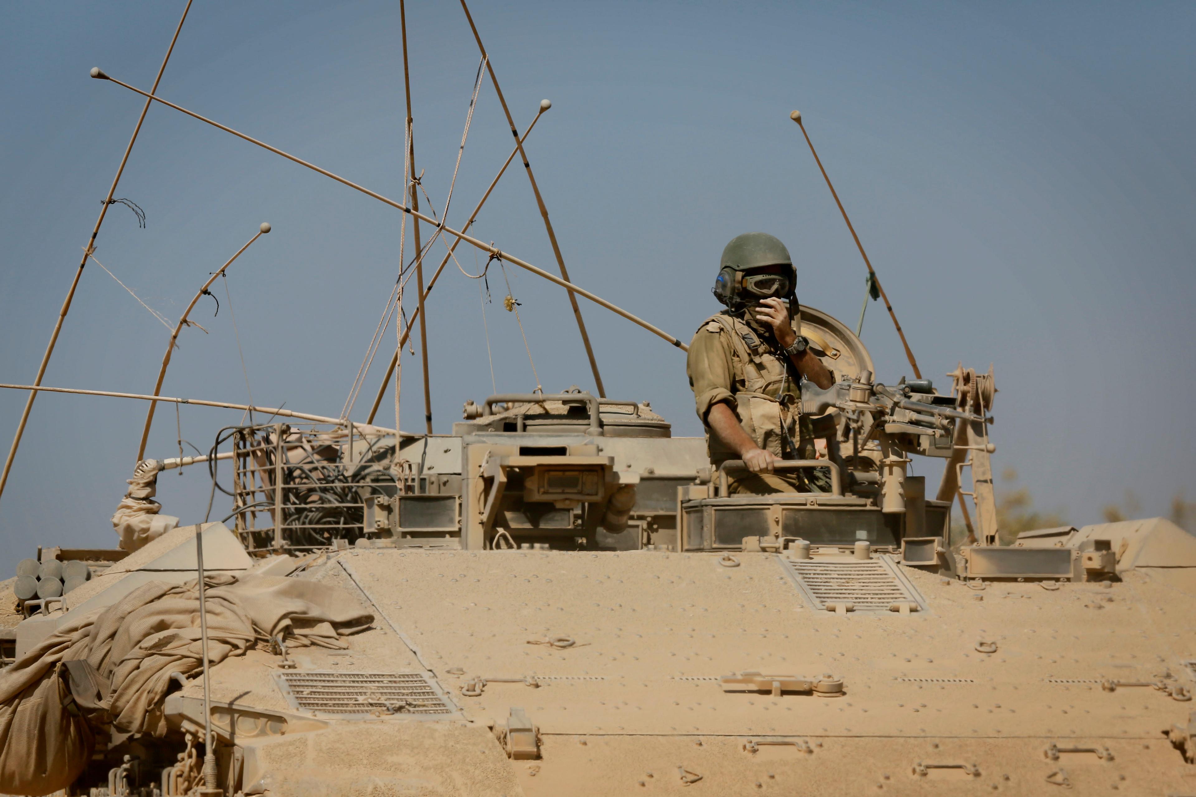An Israeli soldier seen inside an IDF tank before crossing through a field near the Israeli border with Gaza. 