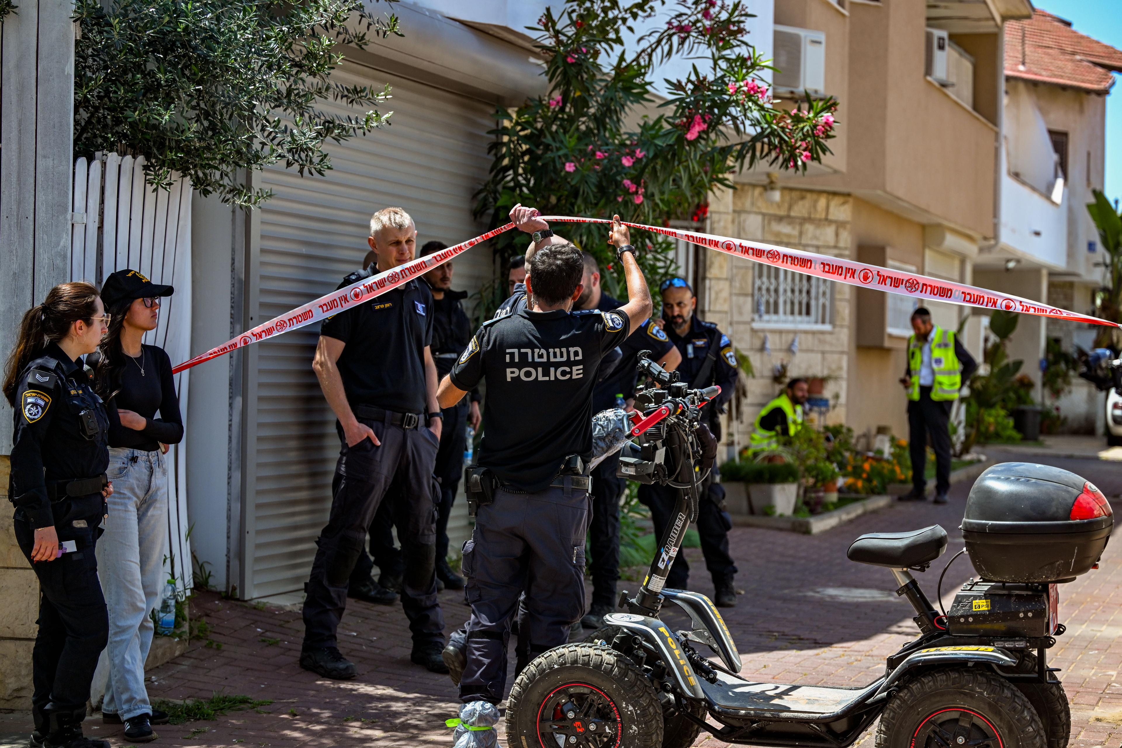Police at the scene where a woman found buried in yard of house.