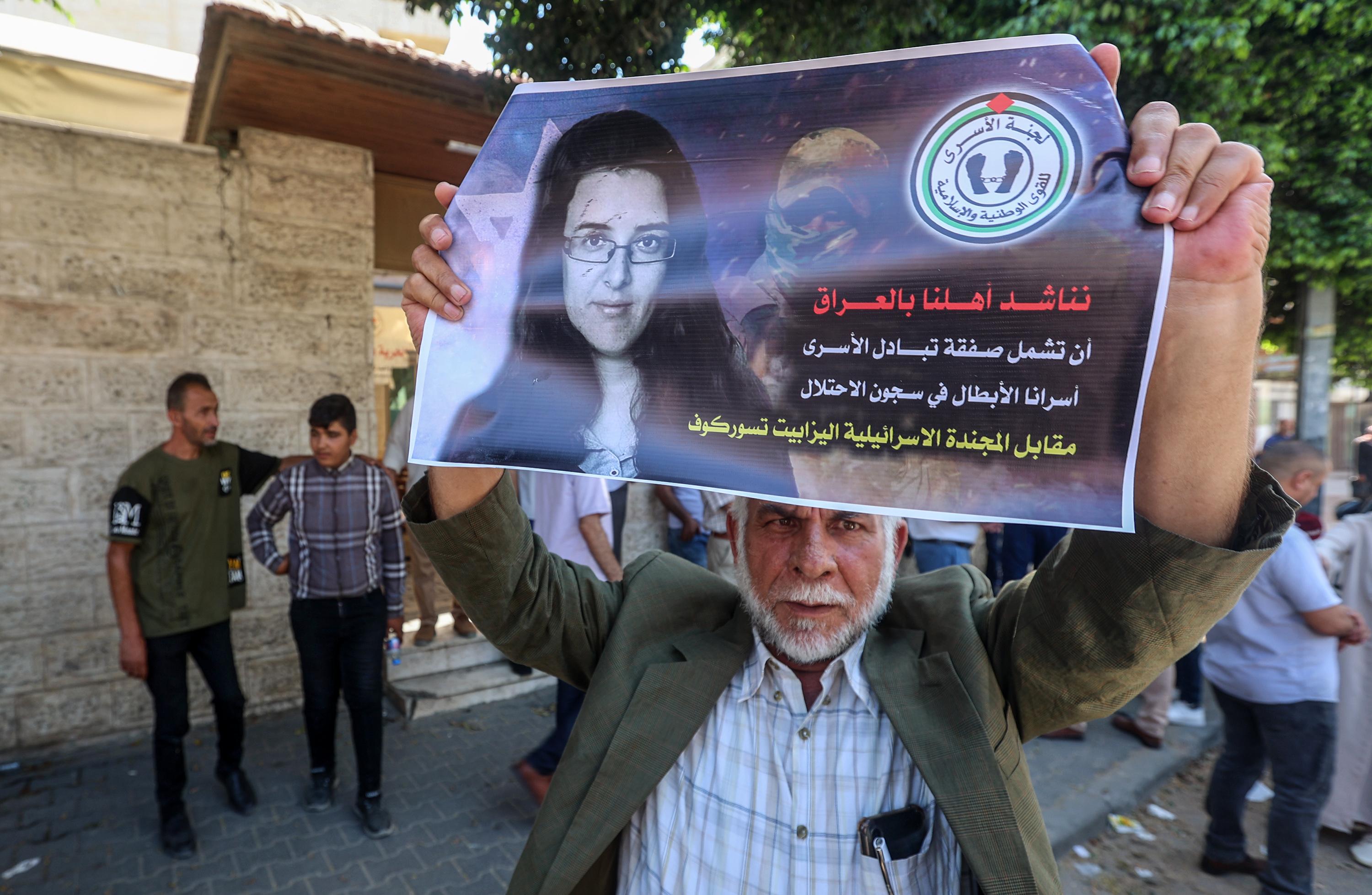 Palestinians raise pictures of Israeli-Russian researcher Elizabeth Tsurkov, who was kidnapped in Iraq, during a demonstration demanding not to release her, in front of the International Red Cross, in Gaza City, on July 17, 2023. 