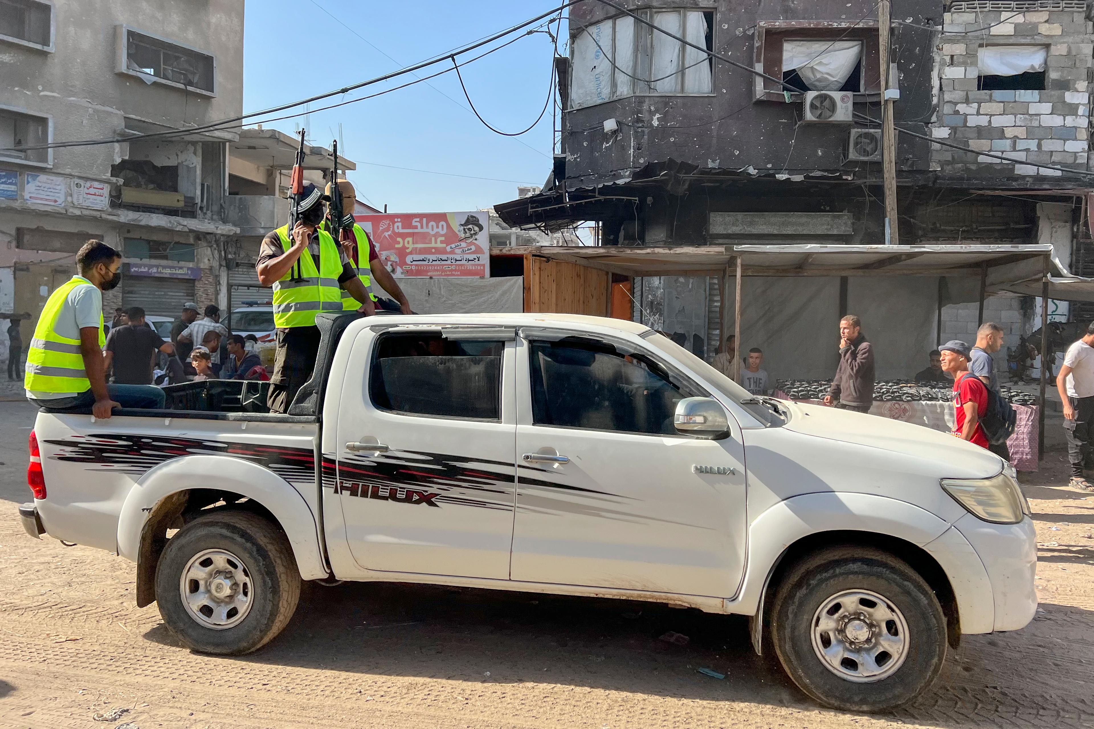 Masked Palestinian gunmen seize control of trucks carrying aid entering the southern Gaza Strip through the Kerem Shalom crossing, on October 11, 2025.