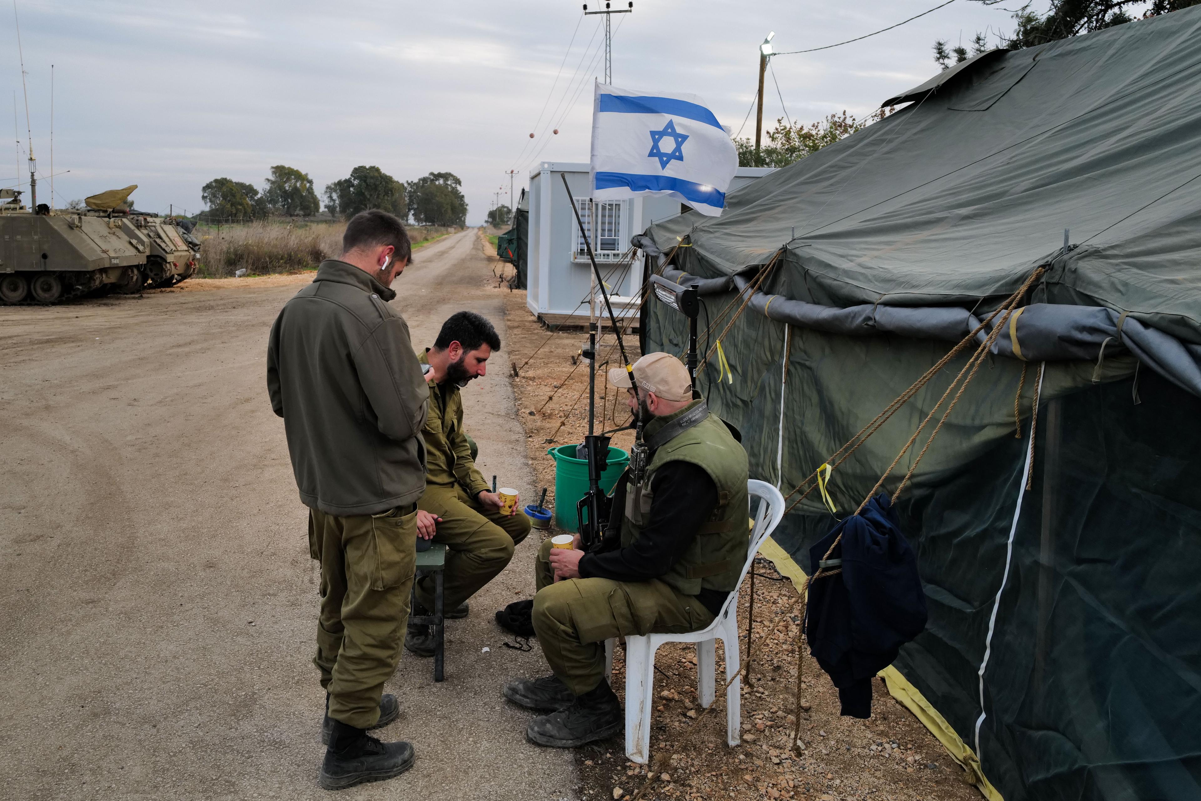 Israeli soldiers seen at a staging area near the Israeli border with Syria, on December 8, 2023. Pictured soldiers are not related to the article.