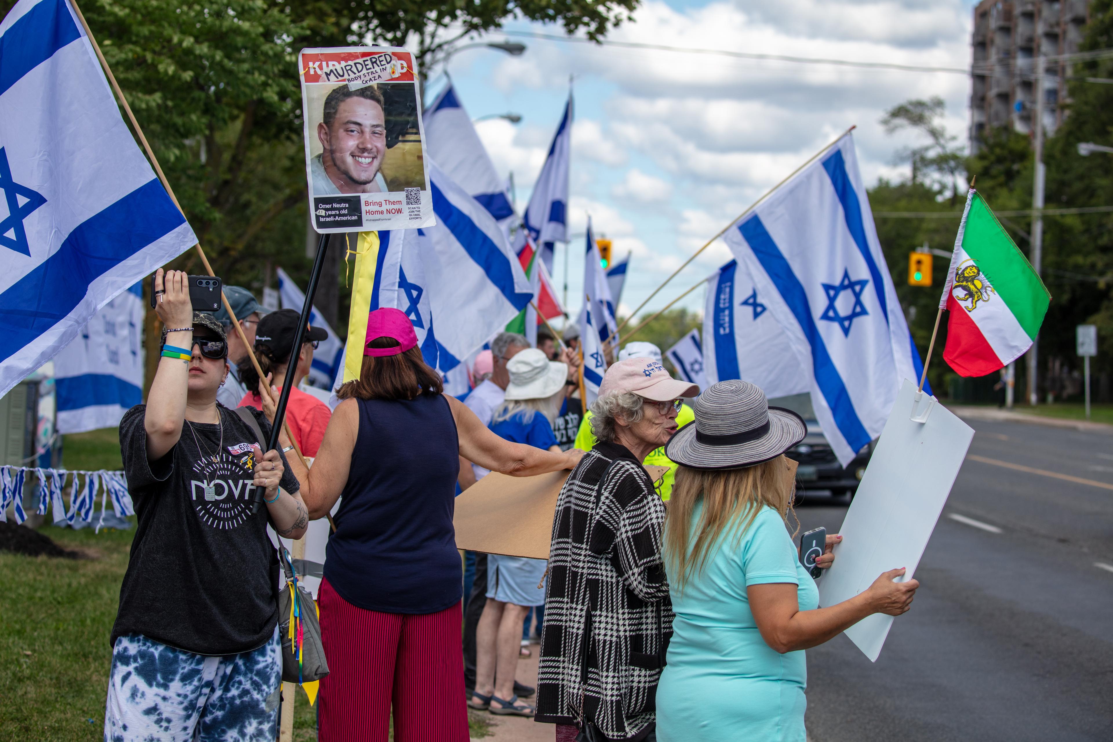 People protest in support of Israel and call for the release of hostages held in Gaza, while across the road pro-Hamas demonstrators rally in their support, in Toronto, Canada, August 31, 2025. 